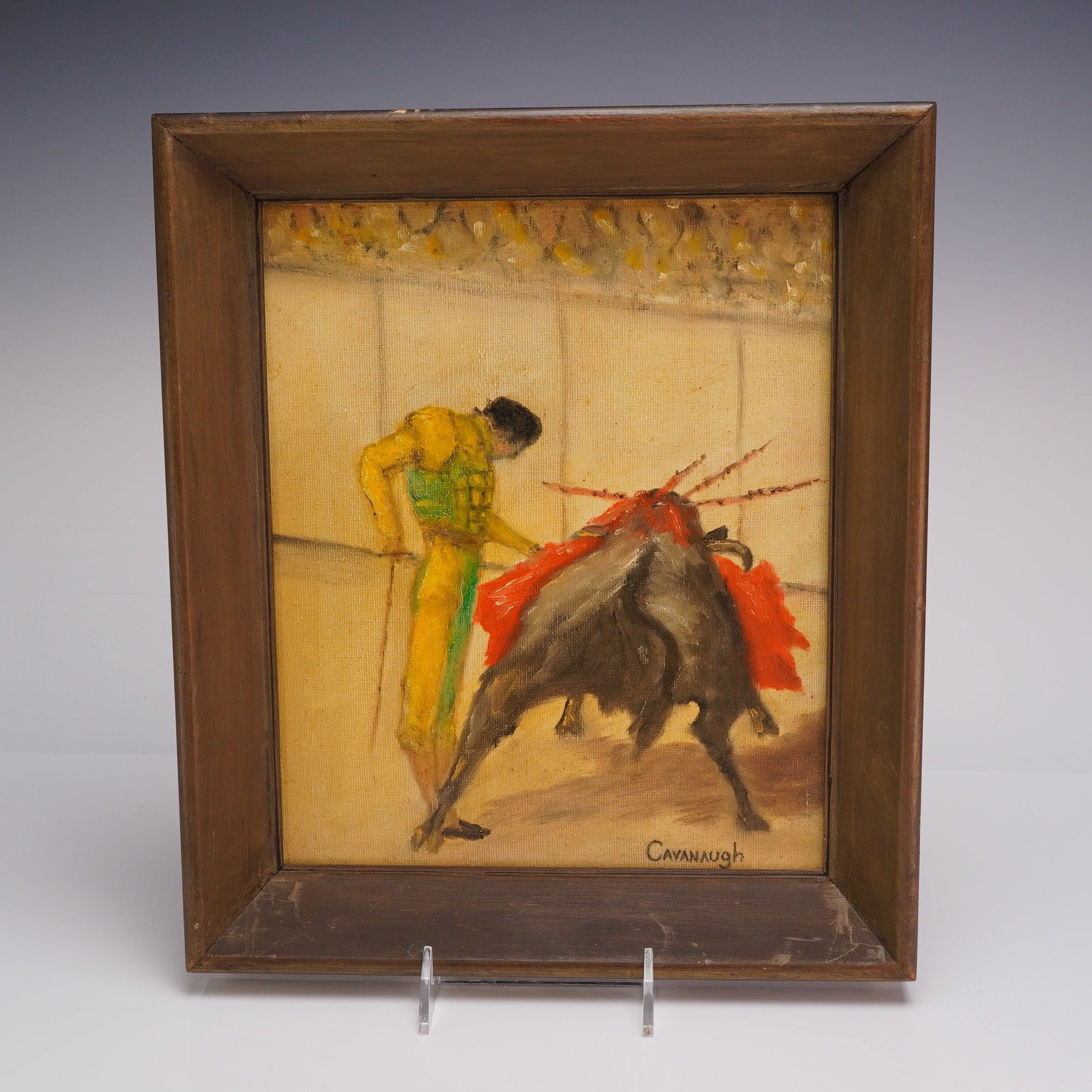 Cavanaugh, Spanish Bullfighting Scene Oil on Canvas: This oil on canvas painting by the artist Cavanaugh depicts a Spanish bullfighting scene. The composition features a matador in a vibrant yellow and green suit of lights engaged with a bull adorned wi