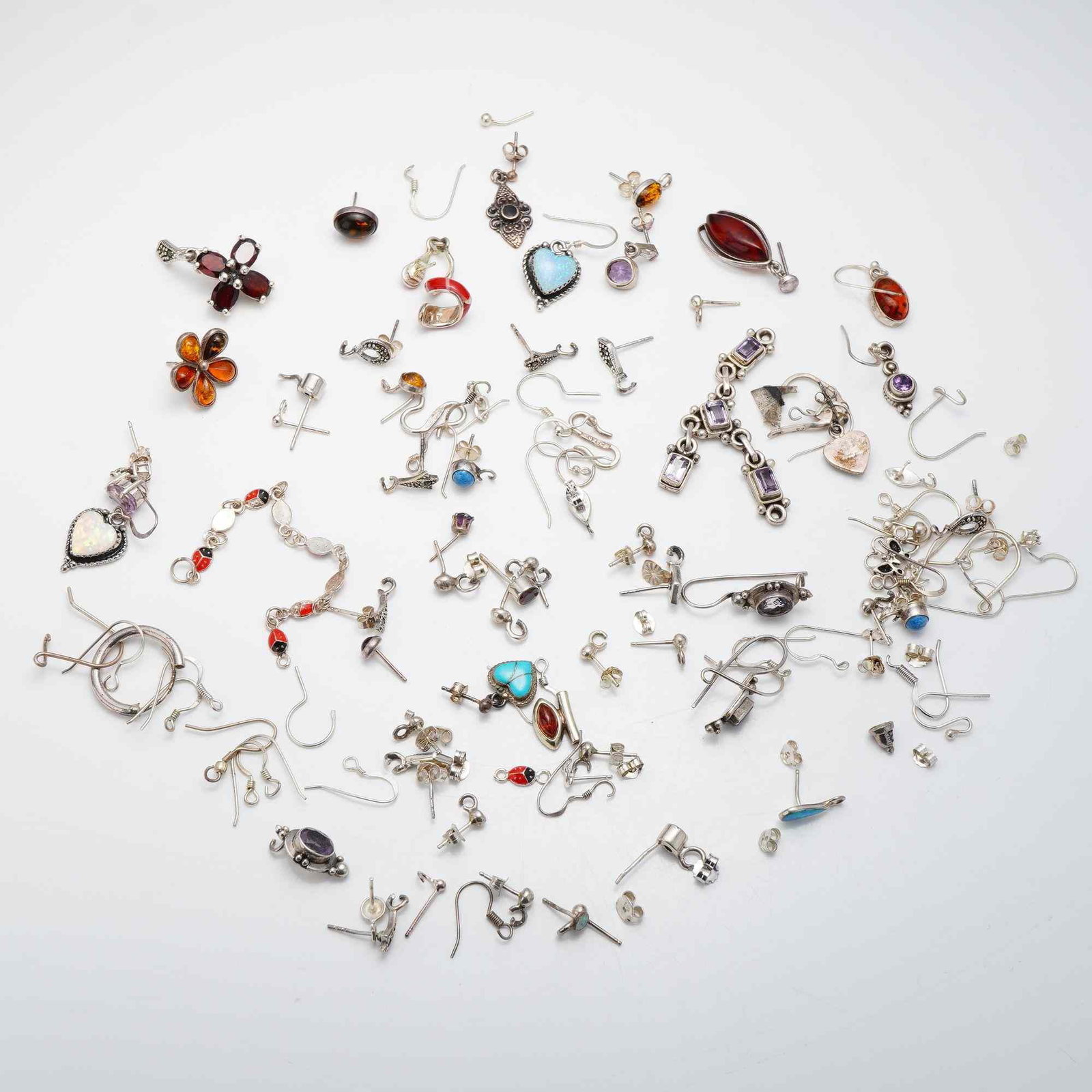 Group Lot of Vintage Sterling Silver Mixed Jewelry, Earrings and Pendants: An assortment of vintage sterling silver jewelry pieces, primarily consisting of earrings along with several pendants. The collection includes a diverse range of styles such as studs, drops, dangles, 