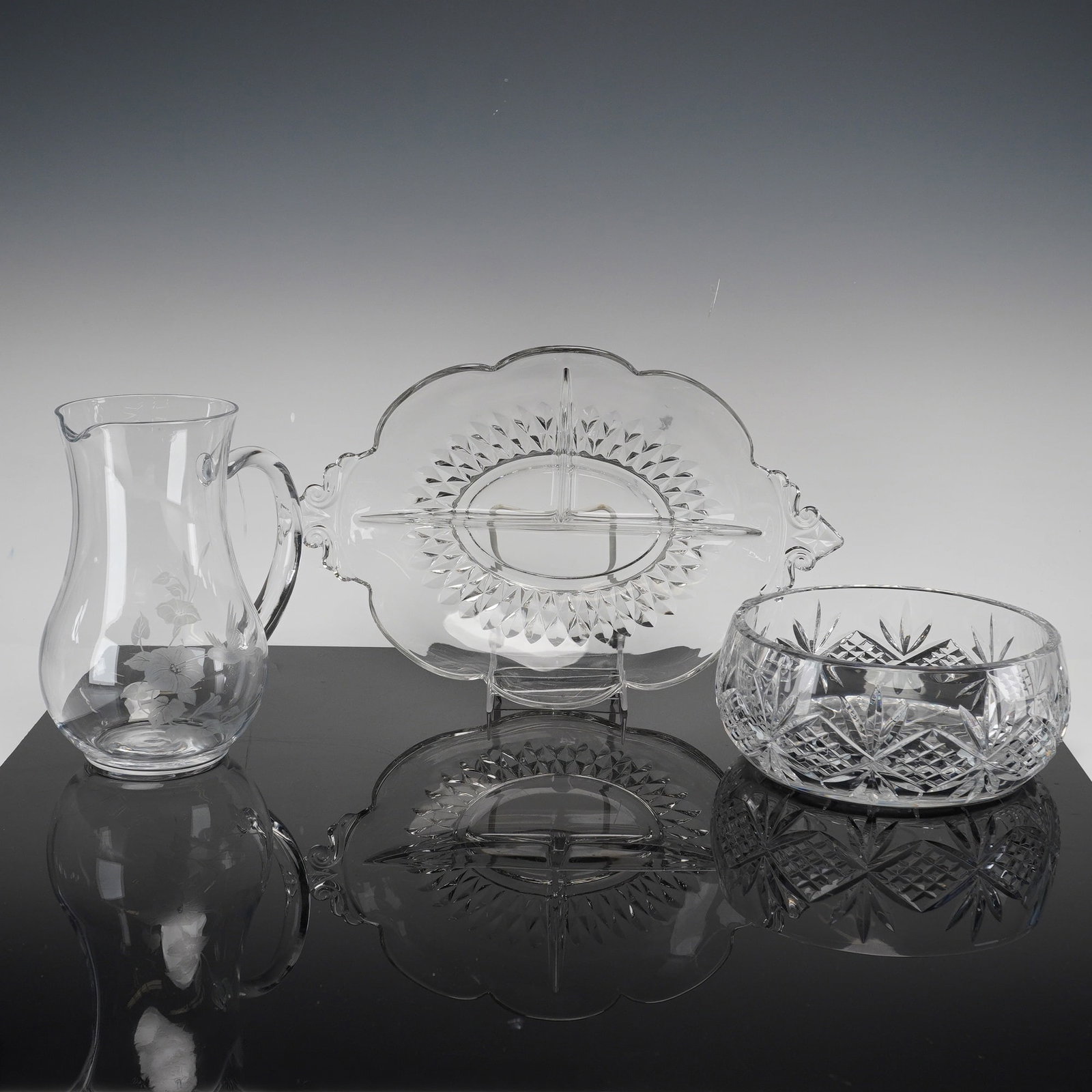 Three Pieces of Cut, Pressed, and Etched Glass Tableware: This collection consists of 3 glass tableware items featuring various decorative techniques. The first item is a deep-cut lead crystal bowl designed in the style of the American Brilliant Period. The 