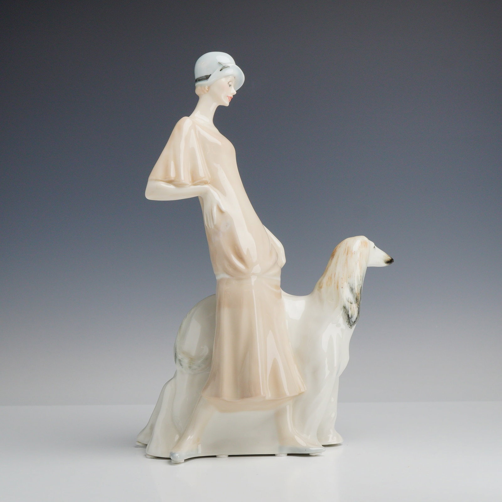Royal Doulton Reflections Series Porcelain Figurine Promenade HN 3072: This Royal Doulton porcelain figurine, titled Promenade (model HN 3072), is a part of the Reflections series. The piece is crafted from glazed porcelain and features a high-gloss finish. The subject m