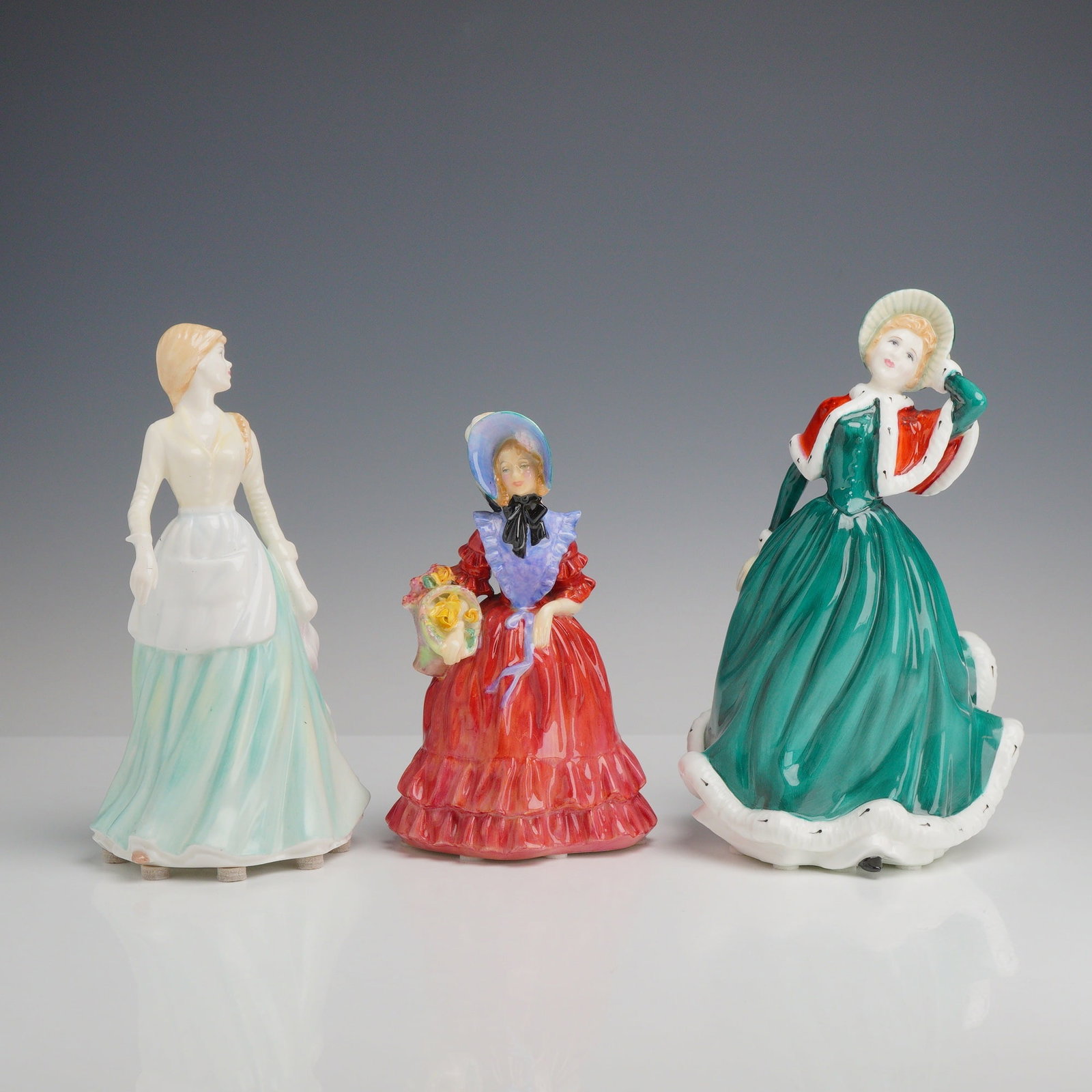 3pc Royal Doulton Bone China Figurines, Milk Maid, Lady Betty, and Christmas Day: This lot features three glazed bone china figurines manufactured by Royal Doulton. The collection includes Milk Maid (HN 4305) from the Classics Country Maid Collection, designed by Nada M. Pedley and
