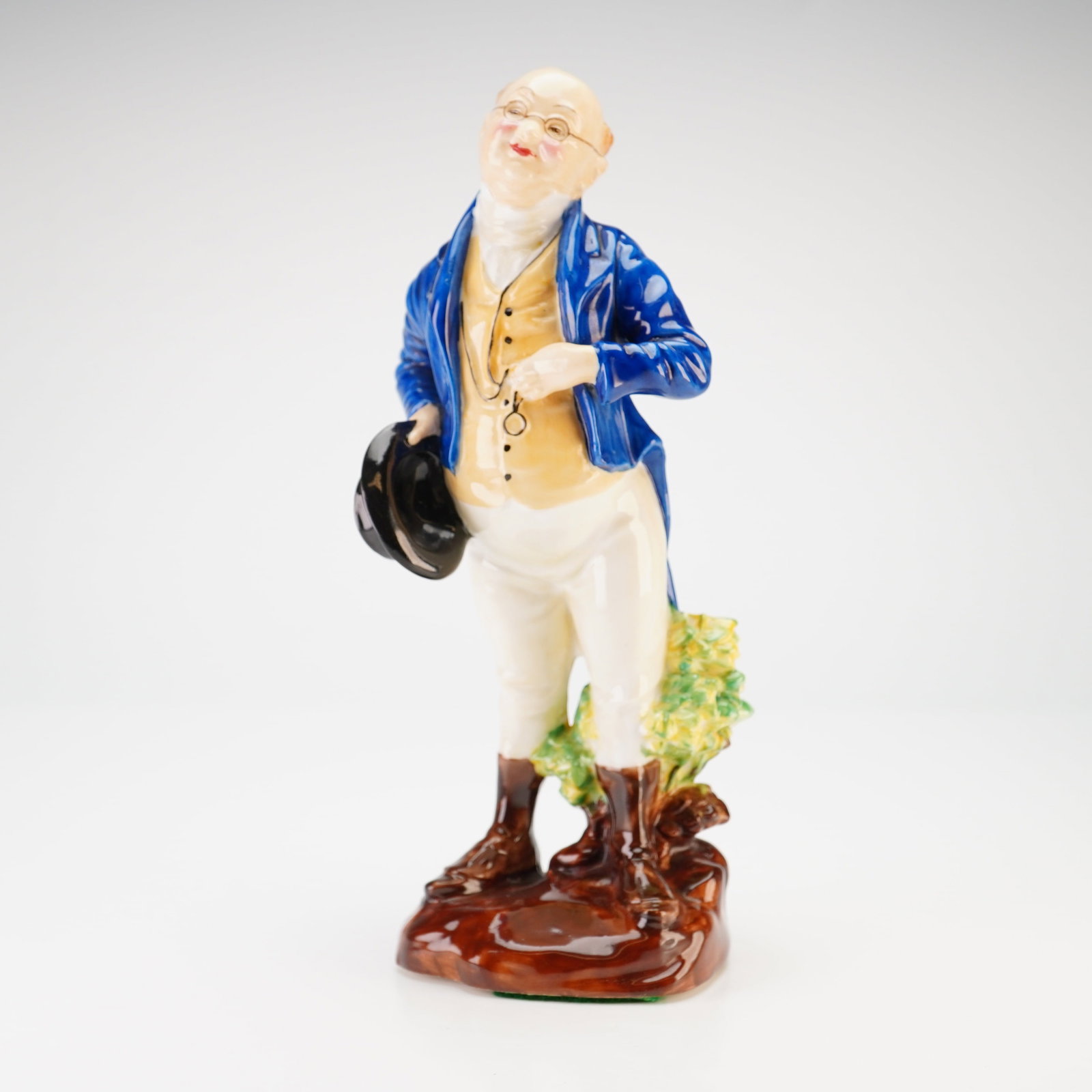 Royal Doulton Mr. Pickwick Bone China Figurine HN 556 Signed: This Royal Doulton bone china figurine depicts the character Samuel Pickwick from Charles Dickens' The Pickwick Papers. Modeled by artist Leslie Harradine, the figure features a portly gentleman in a 