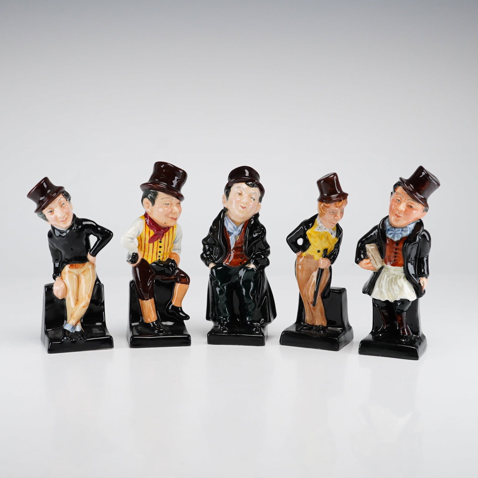 5pc Royal Doulton Miniature Dickens Character Figurines: A set of five hand-painted bone china miniature figurines from the Dickens Character series by Royal Doulton. Each figure is modeled after a specific character from the novels of Charles Dickens, incl