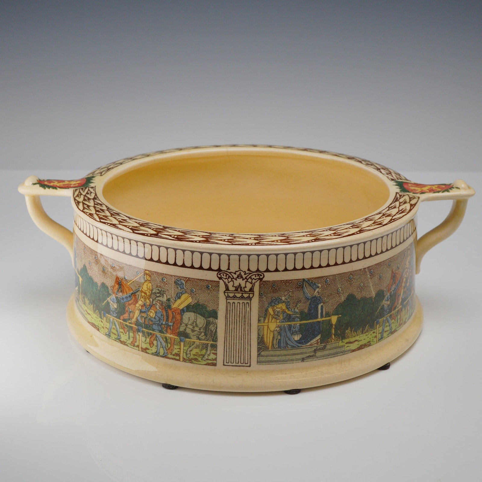 Royal Doulton King Arthur's Knights Seriesware Bowl: Royal Doulton King Arthur's Knights Seriesware Bowl, designed as a low-profile cylindrical ferner or bulb bowl. Constructed of earthenware, the piece displays transfer-printed and hand-colored ornamen