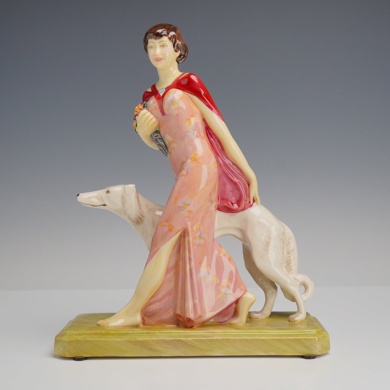 Kevin Francis Limited Edition Porcelain Figurine Rosa Canina by Geoff Blower: A Kevin Francis hand-painted porcelain figurine titled Rosa Canina, modeled by Geoff Blower and produced by Peggy Davies Ceramics. The figure features an Art Deco style woman in a walking pose, wearin