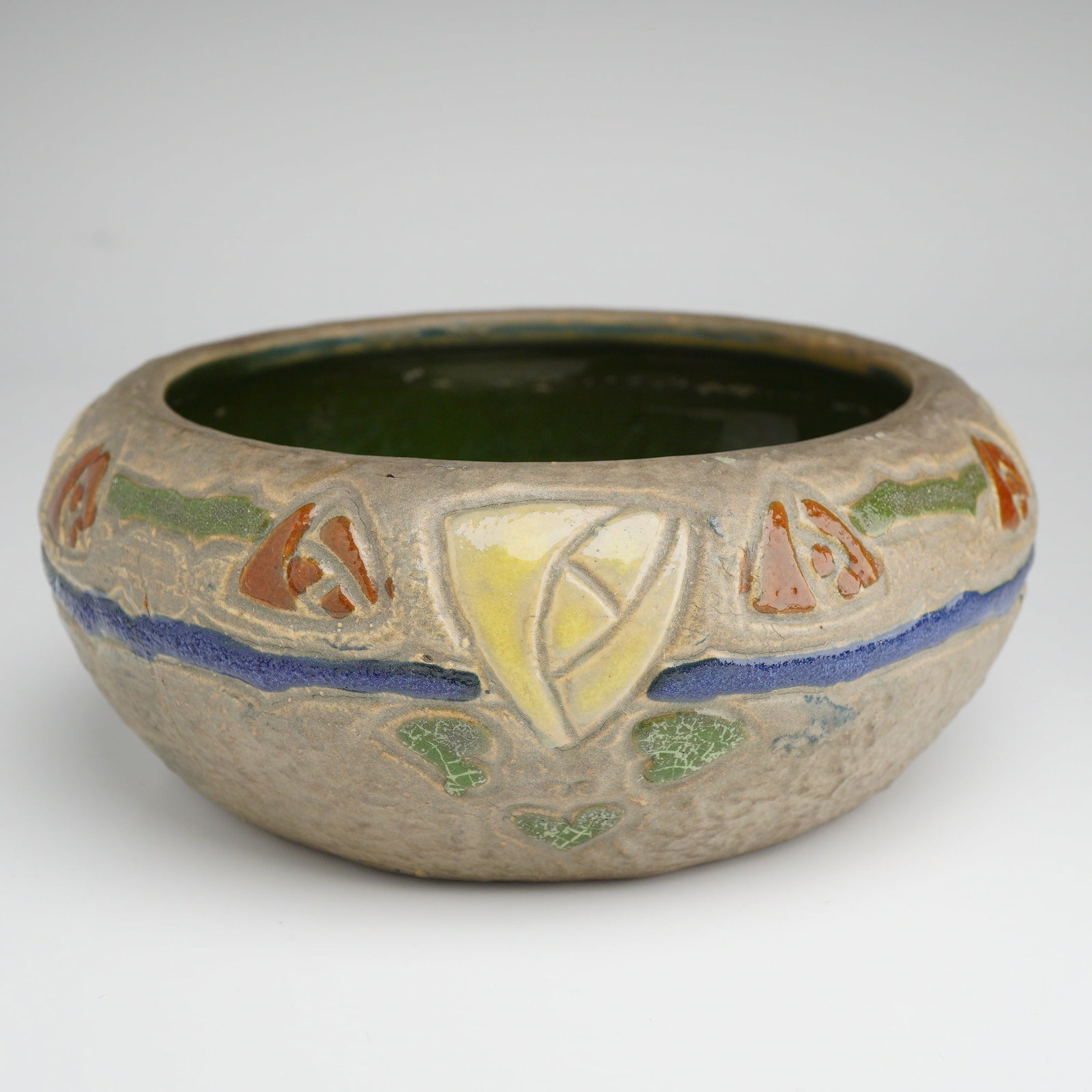 Roseville Pottery Gray Tulip Bowl, Mostique: A Roseville Art Pottery Mostique pattern bowl, produced circa 1916-1932. This ceramic vessel features a squat, bulbous form with a textured, matte gray exterior. The body is decorated with a circumfer
