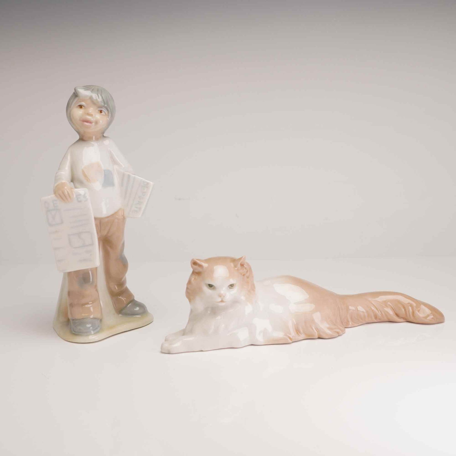 Two Spanish Porcelain Figurines Including Nao by Lladro Cat and Tengra Boy with Newspapers (1 of 5)