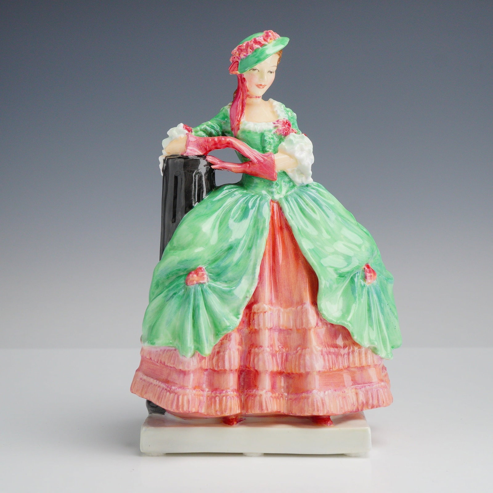 Royal Doulton Bone China Figurine Kate Hardcastle HN 1719: This Royal Doulton bone china figurine, titled Kate Hardcastle, features the model number HN 1719. The piece is crafted in polychrome glazed bone china and depicts a woman in 18th-century costume. She