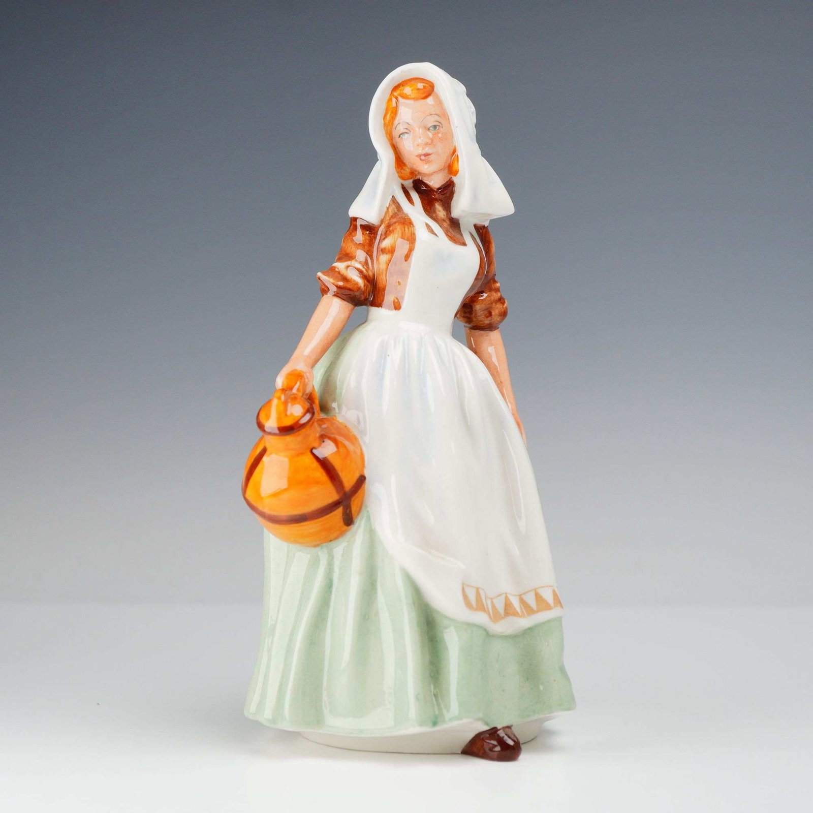 Royal Doulton Porcelain Figurine, Jersey Milkmaid HN2057: This Royal Doulton hand-painted porcelain figure, titled Jersey Milkmaid and numbered HN2057, was designed by Leslie Harradine and produced between 1950 and 1959. The figurine depicts a young woman in