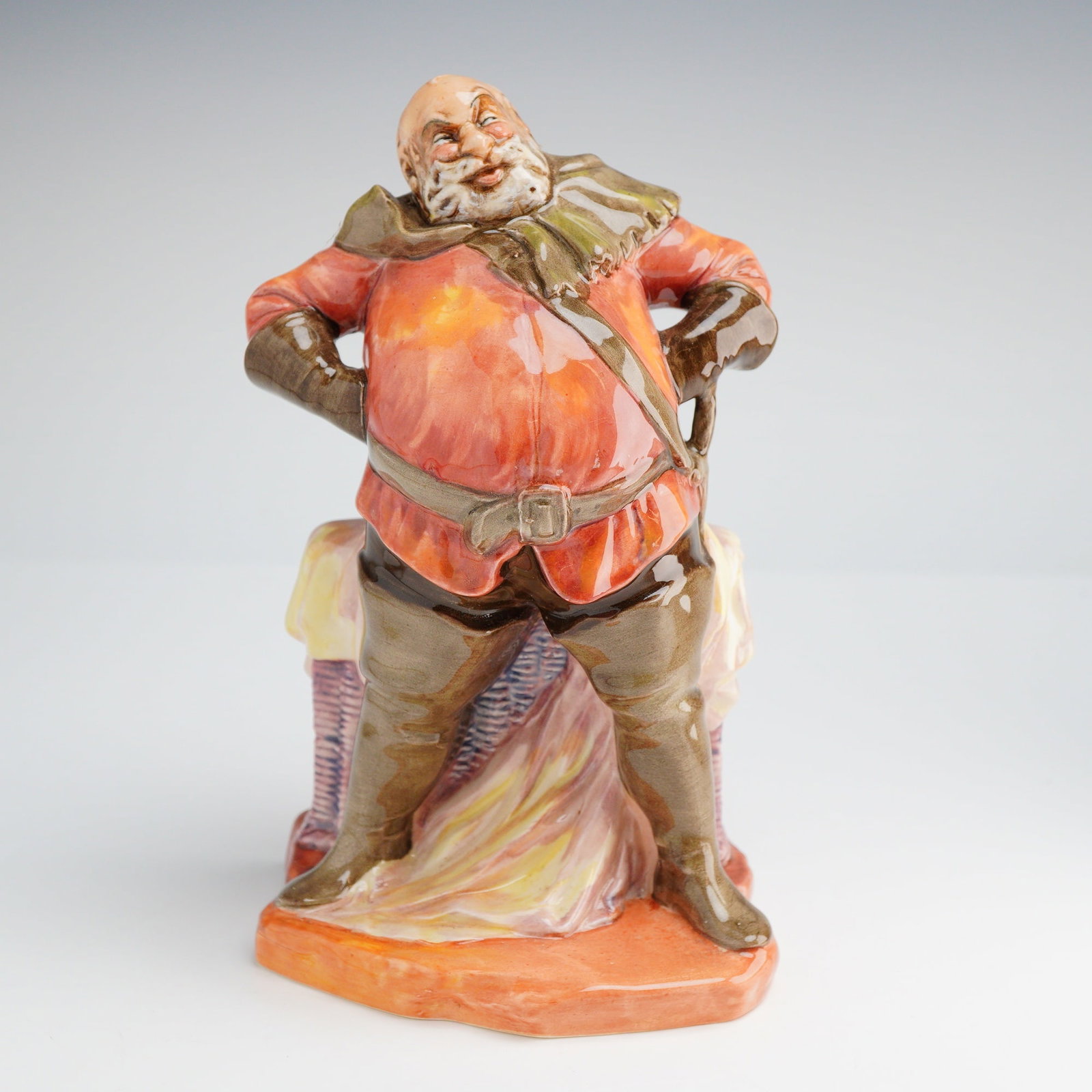 Royal Doulton Falstaff Figurine HN 2054: A Royal Doulton Figurine, Falstaff HN2054, featuring predominant orange-red and brown colors, marked on the base "MADE IN ROYAL DOULTON ENGLAND" and "COPR. 1949. DOULTON & CO. LIMITED." Dimensions: 4.
