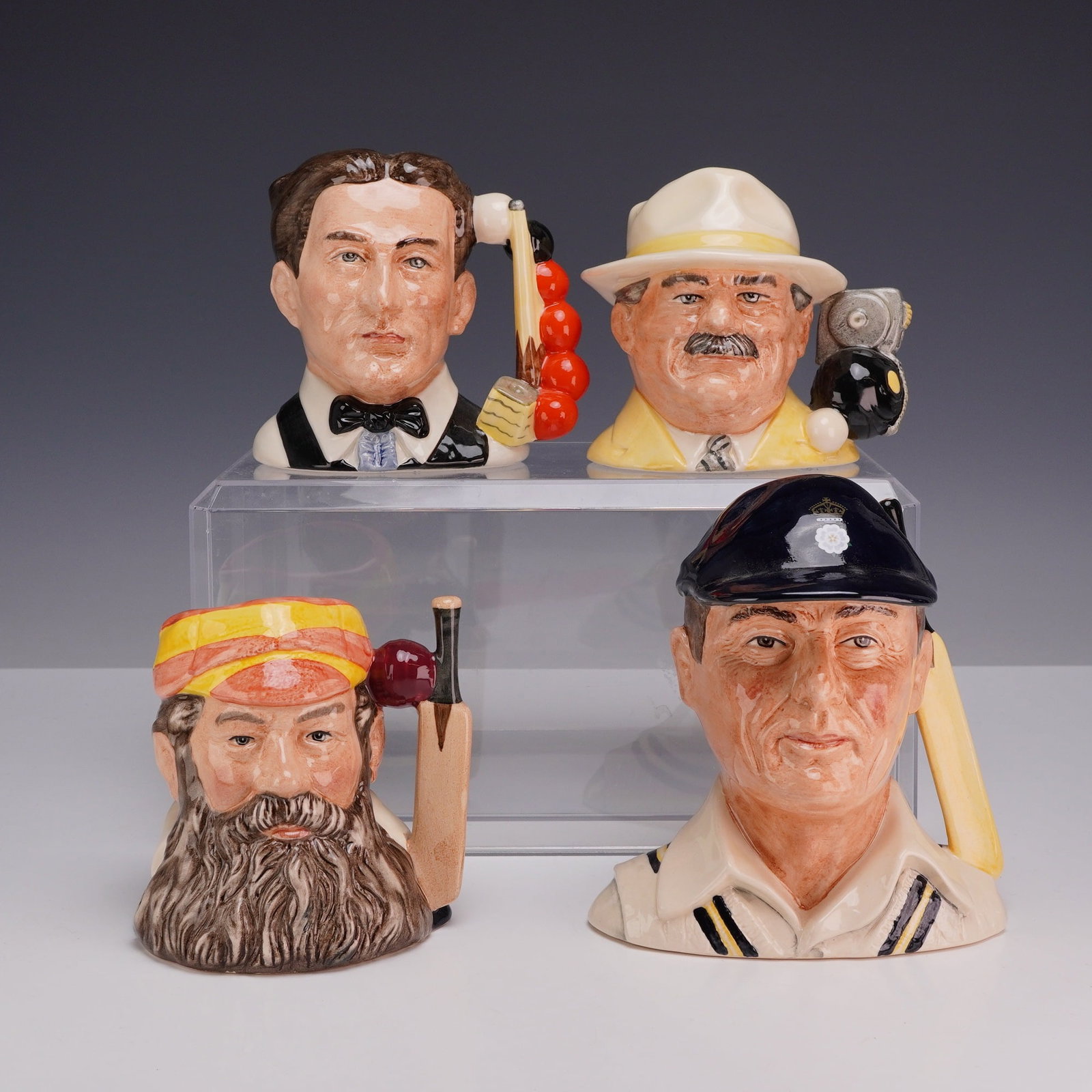 Lot of 4 Royal Doulton Character Jugs Including The Bowls Player, The Snooker Player, The Hampshire: This lot of 4 Royal Doulton character jugs features a collection of glazed ceramic pieces manufactured in England, each themed after a specific sport with handles designed as related equipment. Every 