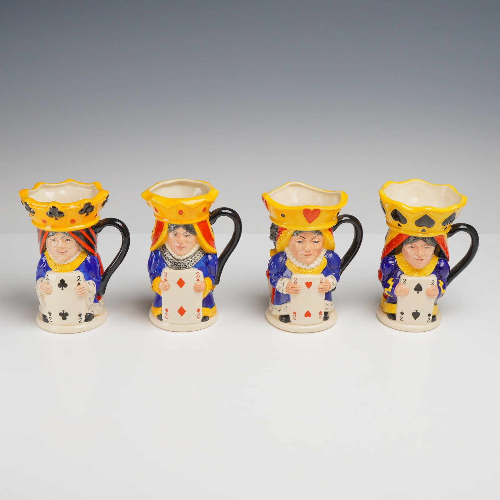 4pc Royal Doulton Limited Edition King and Queen Character Jugs: This group of four glazed earthenware character jugs was produced by Royal Doulton and modeled by Stanley James Taylor. Each jug features a double-sided design representing a suit from a deck of cards