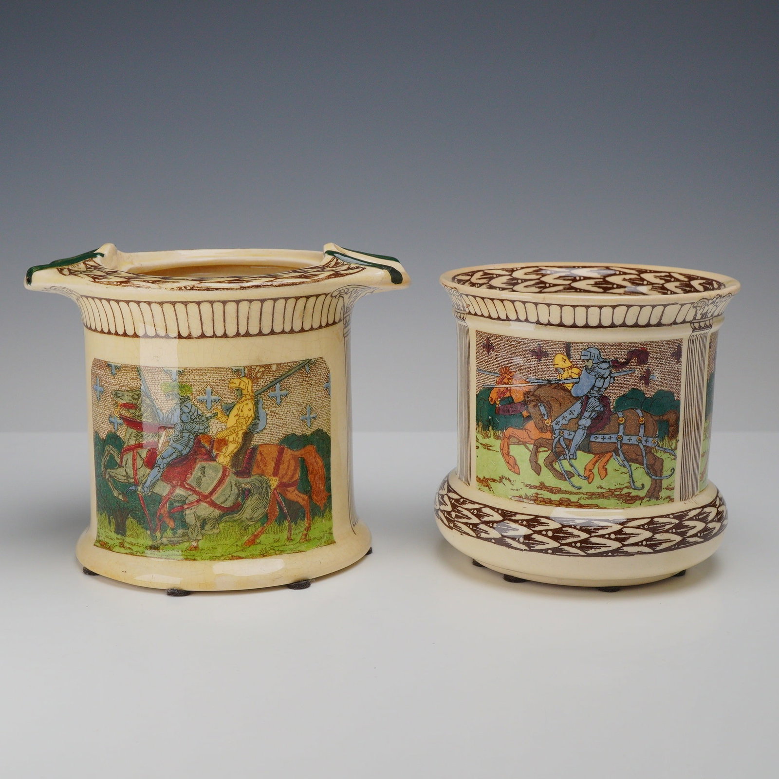 2pc Royal Doulton King Arthur's Knights Seriesware Jars: This is a pair of Royal Doulton earthenware vessels from the King Arthur's Knights Seriesware collection, featuring pattern number D2961. The set consists of two distinct forms: one jar features a fla