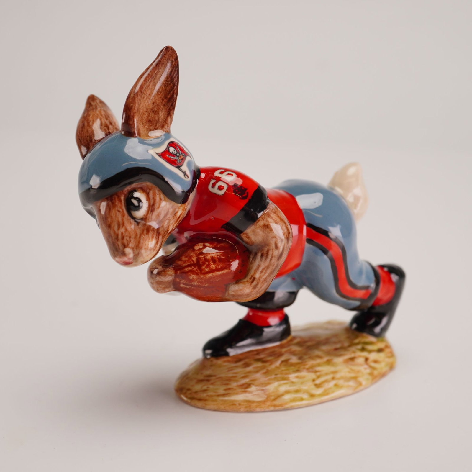 Royal Doulton Prototype Tampa Bay Buccaneers Touchdown Bunnykins: Outstanding prototype decorated in the uniform of the NFL Tampa Bay Buccaneers which features a black trimmed grey helmet with their skull and crossbones flag logo to both sides, number '66' on the re