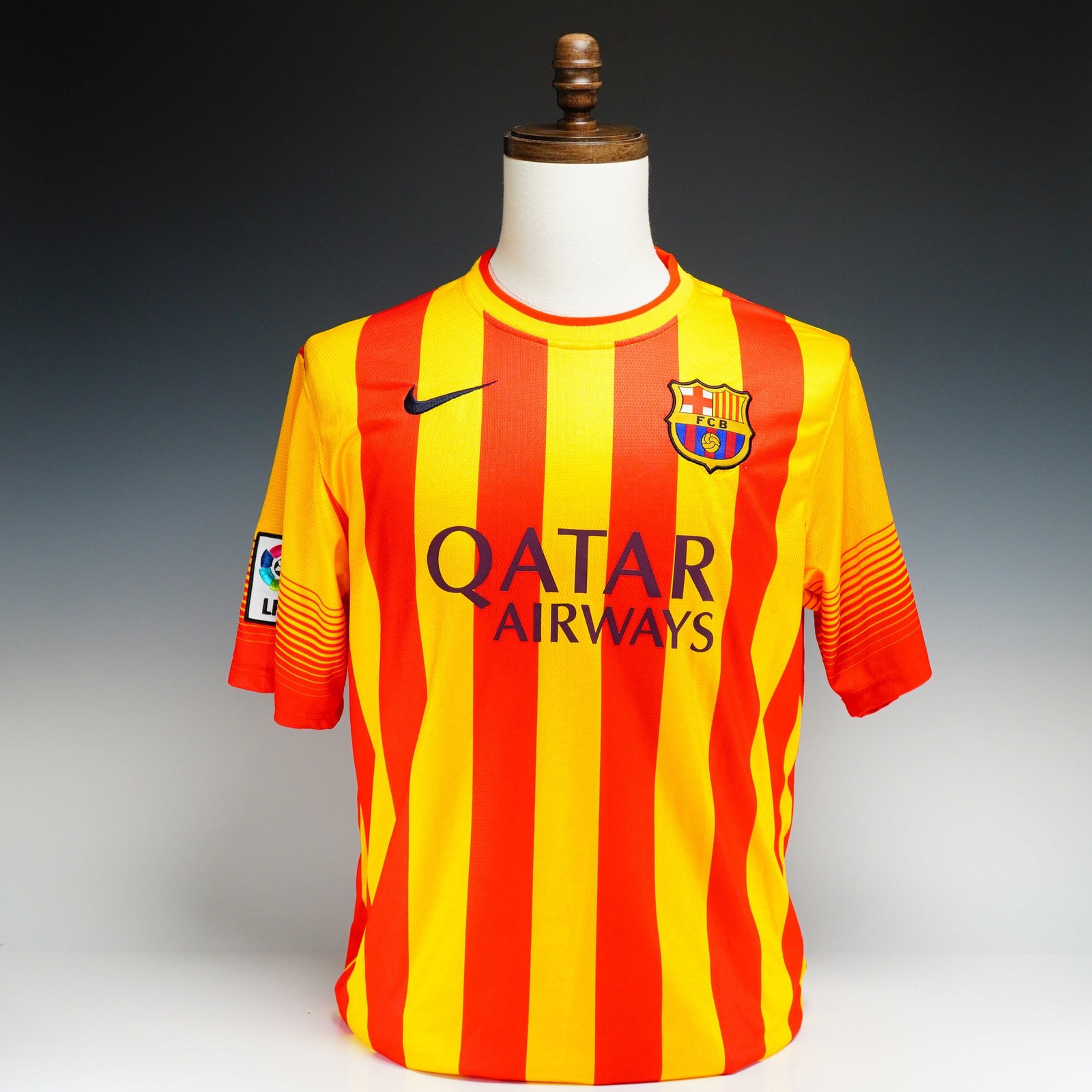Nike FC Barcelona 2013-2014 Away Jersey, Neymar Jr. #11: This is a Nike brand 2013-2014 FC Barcelona away soccer jersey, featuring the yellow and red vertical stripes of the Catalan Senyera flag. The jersey is styled for player Neymar Jr. with his name and 