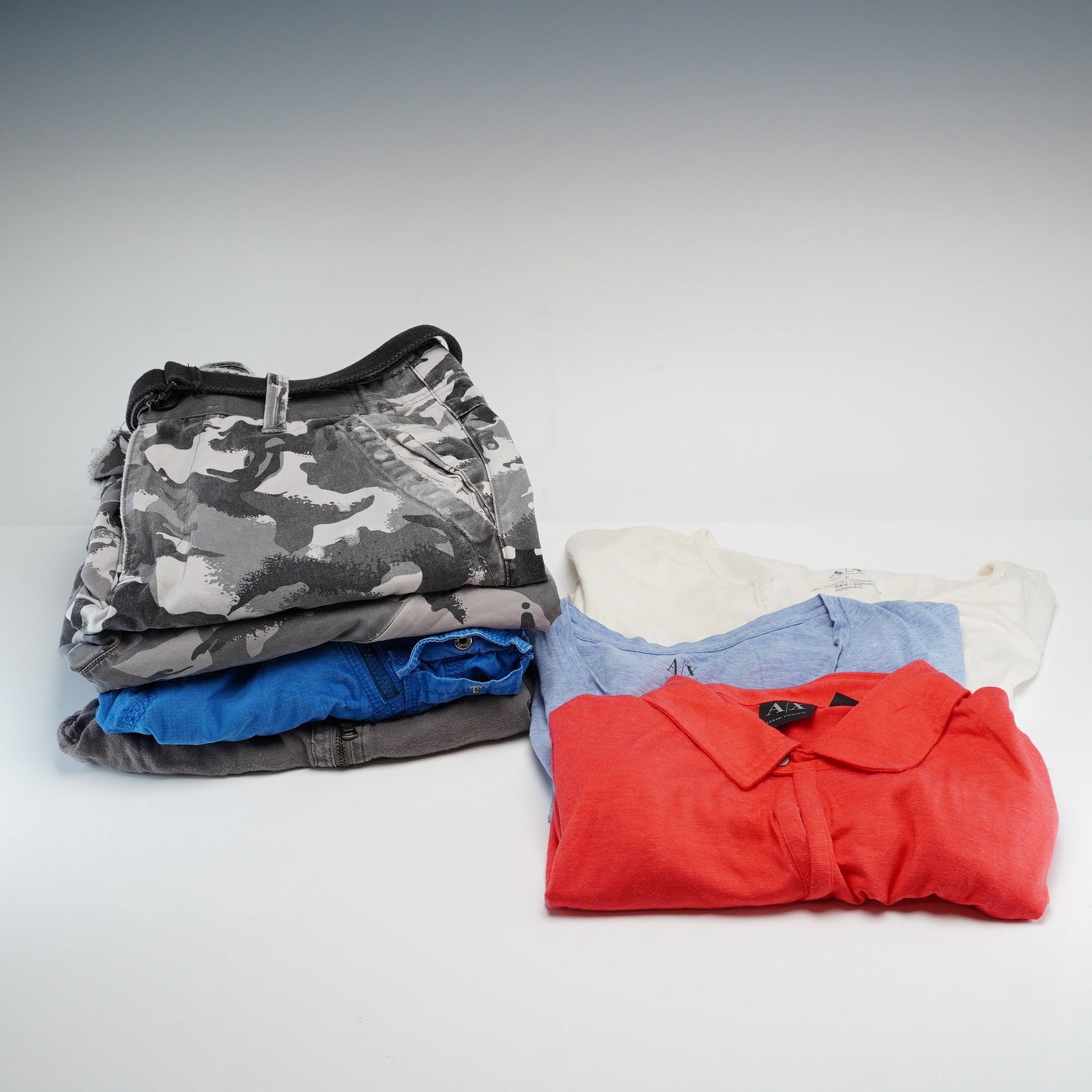 7pc Armani Exchange Men's Short Sleeve Shirts and Shorts: A collection of seven items of men's designer clothing from Armani Exchange (A|X). This lot consists of three short-sleeved shirts and four pairs of shorts in various styles and colors. The shirts inc