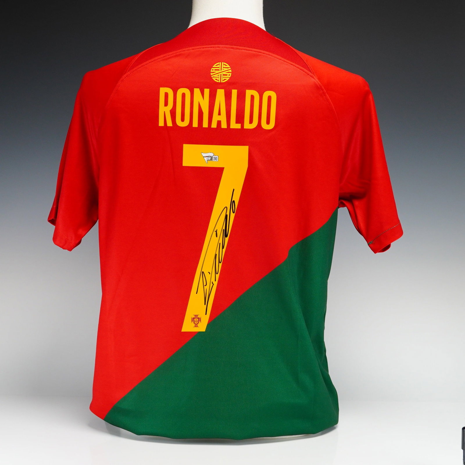 Cristiano Ronaldo Autographed Portugal National Team 2022 Nike Home Jersey with Fanatics Authentic: This is a Cristiano Ronaldo autographed Portugal National Team home jersey produced by Nike for the 2022/2023 season. The shirt features the distinctive diagonal red and green color-block design worn 