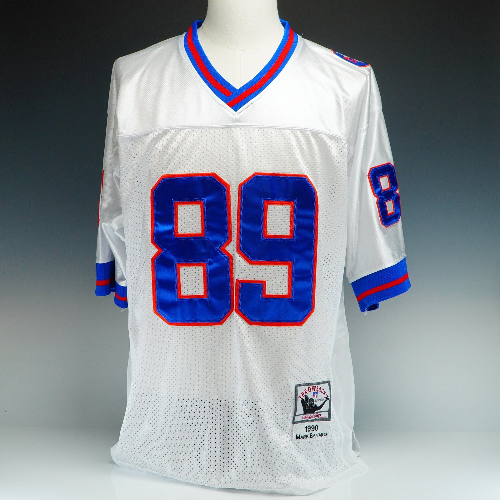 Mitchell & Ness New York Giants Mark Bavaro #89 1990 Away Jersey: This professional Mitchell and Ness Nostalgia Co. Throwbacks jersey replicates the 1990 New York Giants away style worn by tight end Mark Bavaro. Constructed with a white mesh body and solid nylon sho