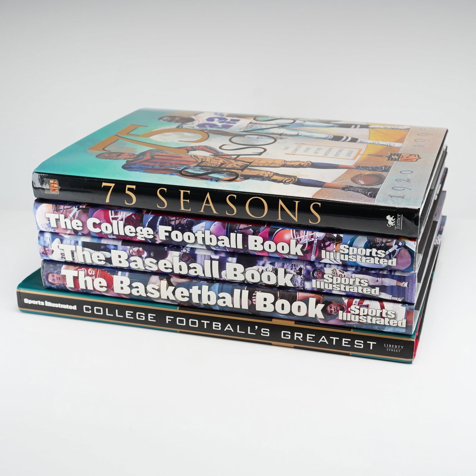 Five Sports Illustrated and NFL Hardcover Books: A collection of five hardcover books documenting the history of American professional and collegiate sports. The group consists of four volumes published by or in association with Sports Illustrated a