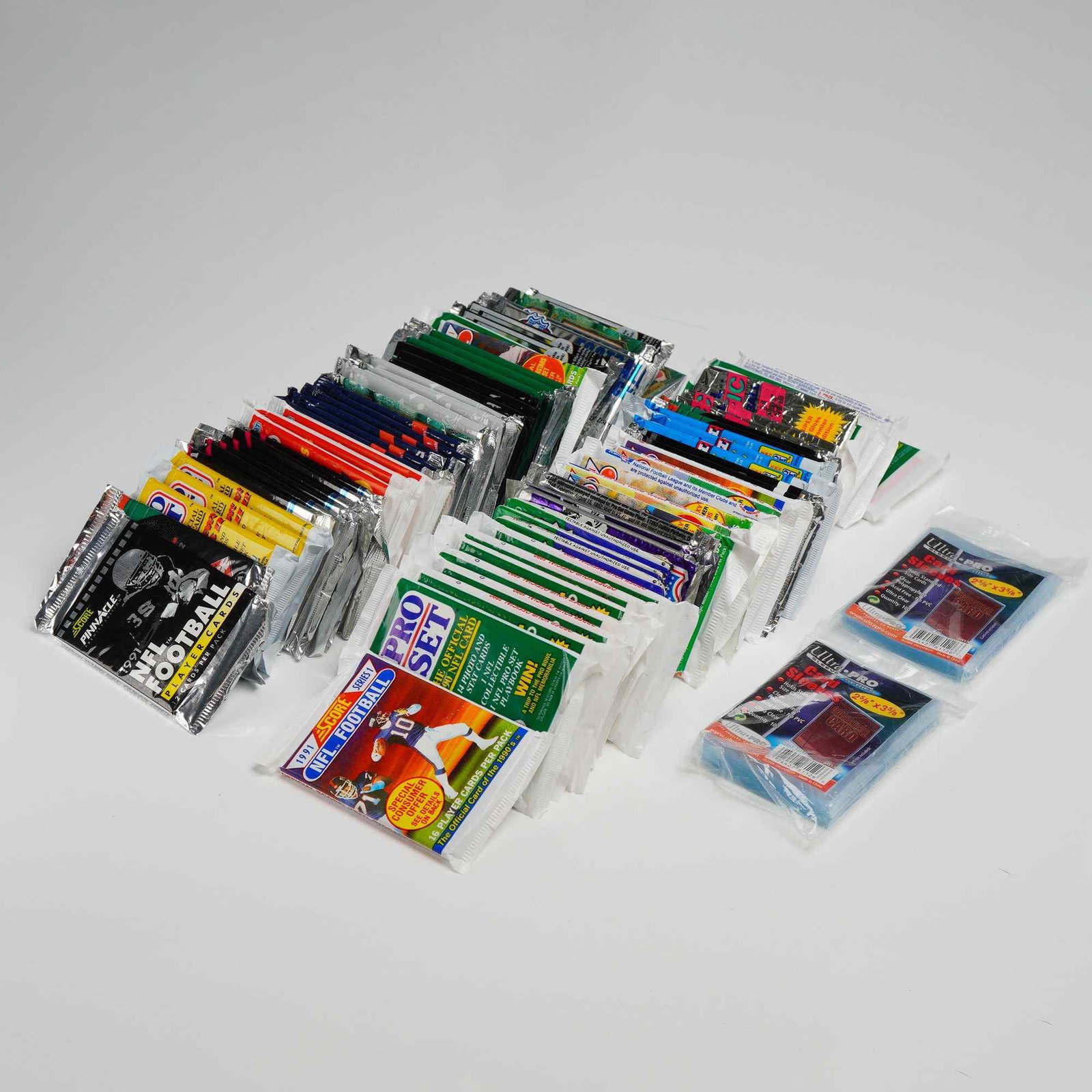 Collection of 77 Unopened Vintage Football Card Packs plus Ultra-PRO Card Sleeves (1 of 2)