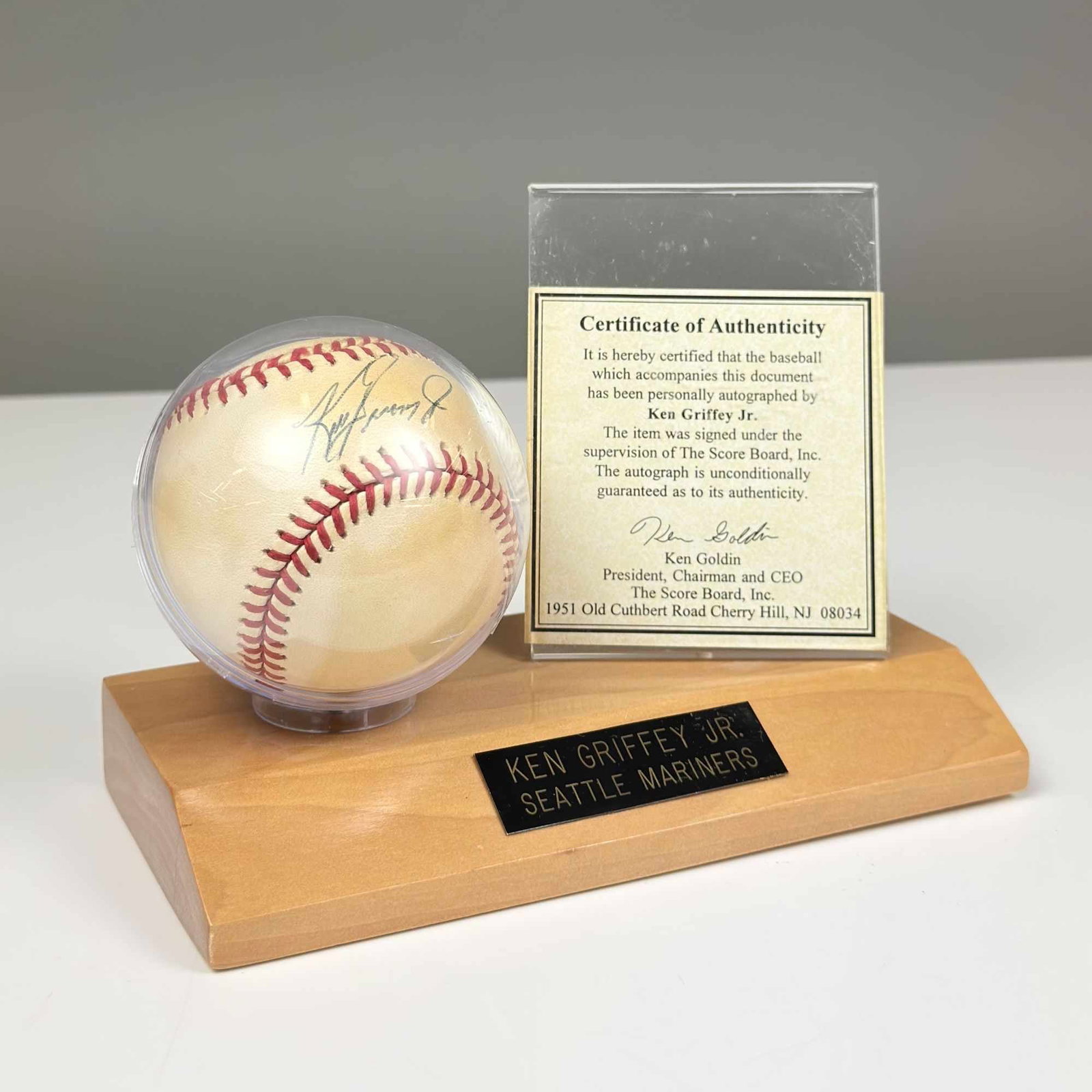 Ken Griffey Jr. Signed Official American League Baseball with COA and Display Stand: This lot features an Official American League baseball personally autographed by Major League Baseball Hall of Famer Ken Griffey Jr. The baseball is a Cushioned Cork Center model bearing the stamped s