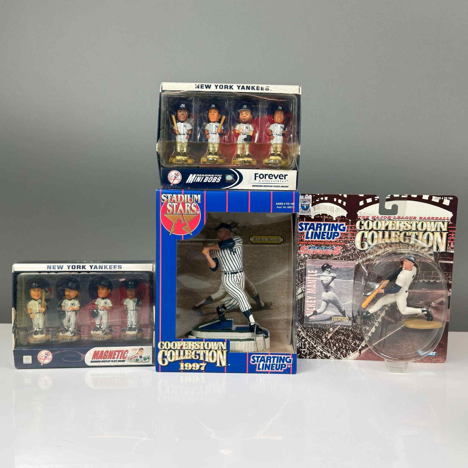 4pc Collectible Mickey Mantle and New York Yankees Player Boxed Figurines: This lot consists of four New York Yankees baseball collectible figurines and sets in their original retail packaging, primarily from the late 1990s. The collection includes a Kenner Starting Lineup S
