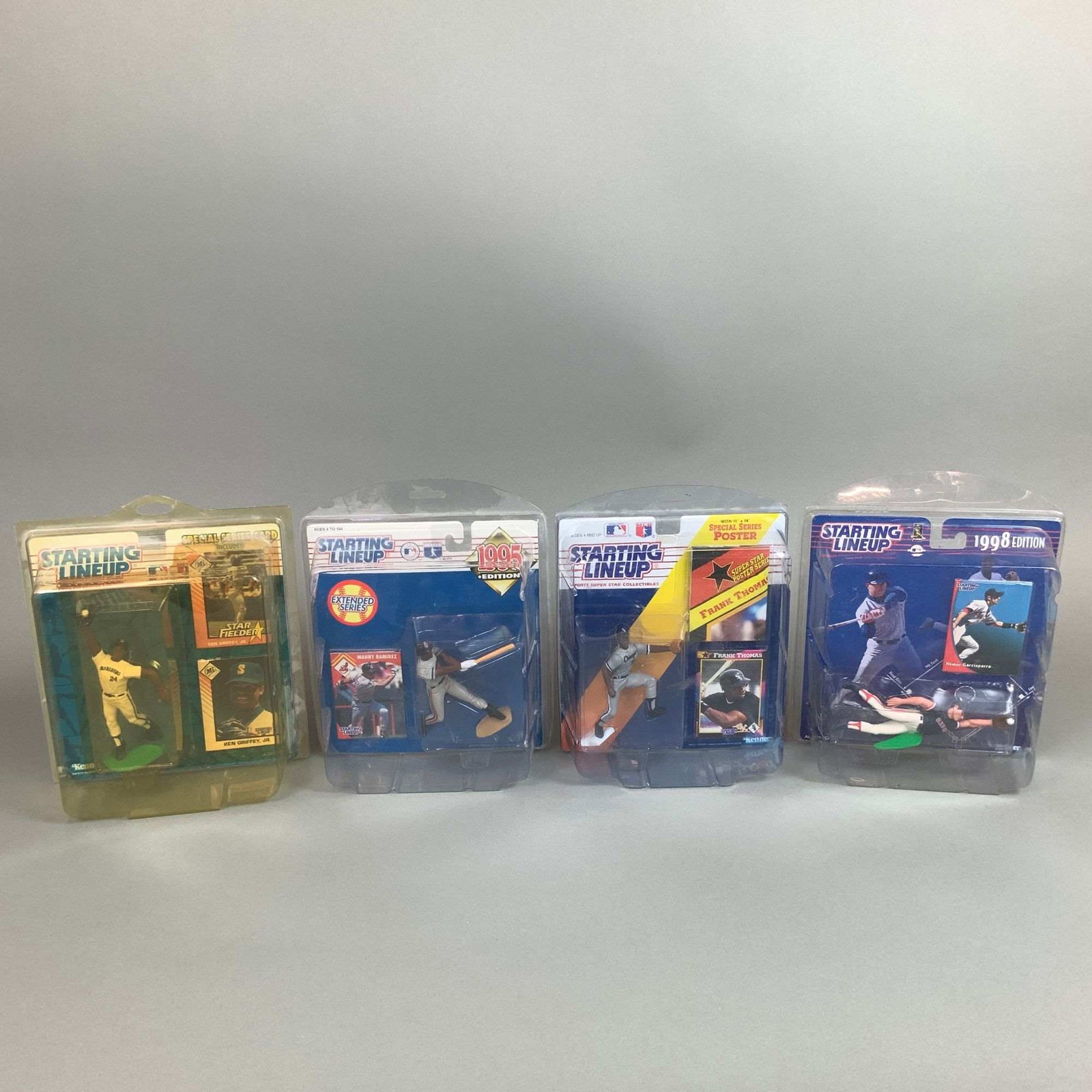 4pc Kenner Starting Lineup MLB Action Figures in Boxes: A collection of four Kenner Starting Lineup Major League Baseball action figures produced between 1992 and 1998. This lot features prominent players in their original factory-sealed blister packaging,