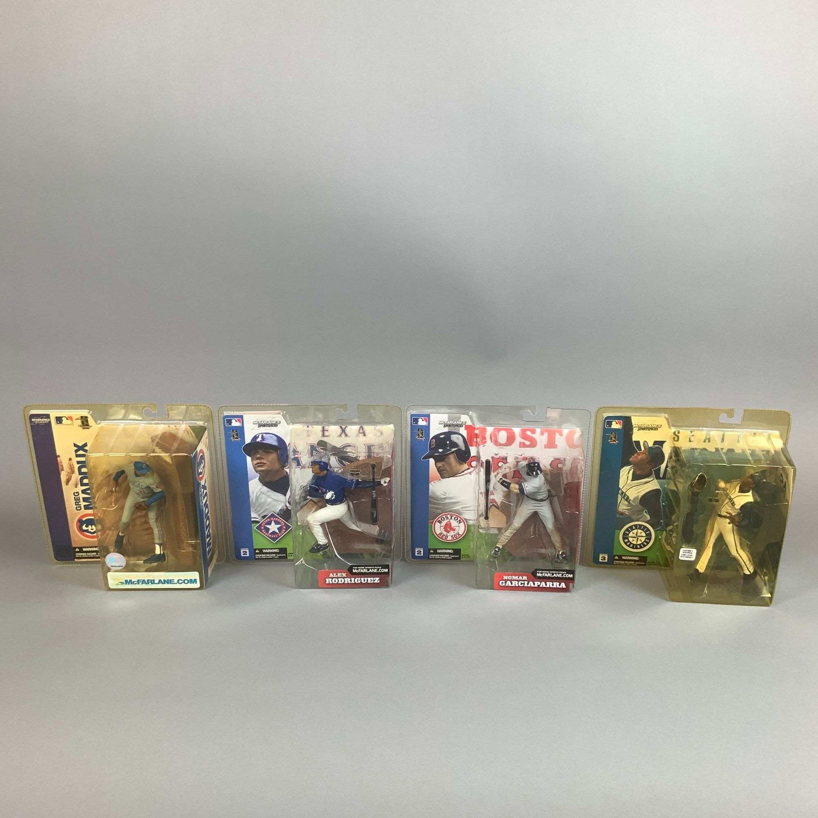 Four McFarlane Toys MLB SportsPicks Action Figures, Maddux Rodriguez Garciaparra and Ken Griffey,: A collection of four McFarlane Toys MLB SportsPicks action figures featuring prominent Major League Baseball players. Each figure is constructed from molded plastic and stands approximately 6 inches t