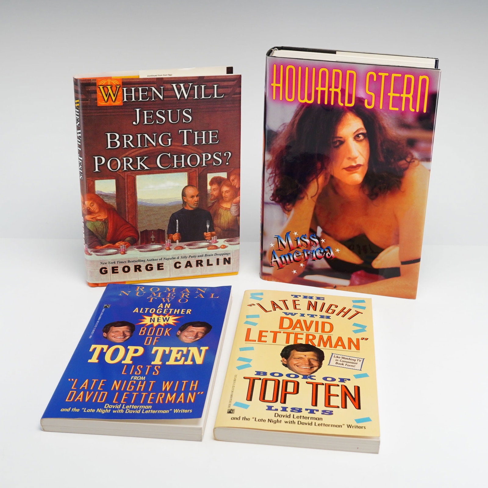 4pc Collection of Hardcover and Softcover Comedy Theme Books including Carlin and Stern.: Four-piece collection of hardcover and softcover comedy theme books featuring works by prominent American comedians. The collection includes two hardcover volumes in dust jackets and multiple