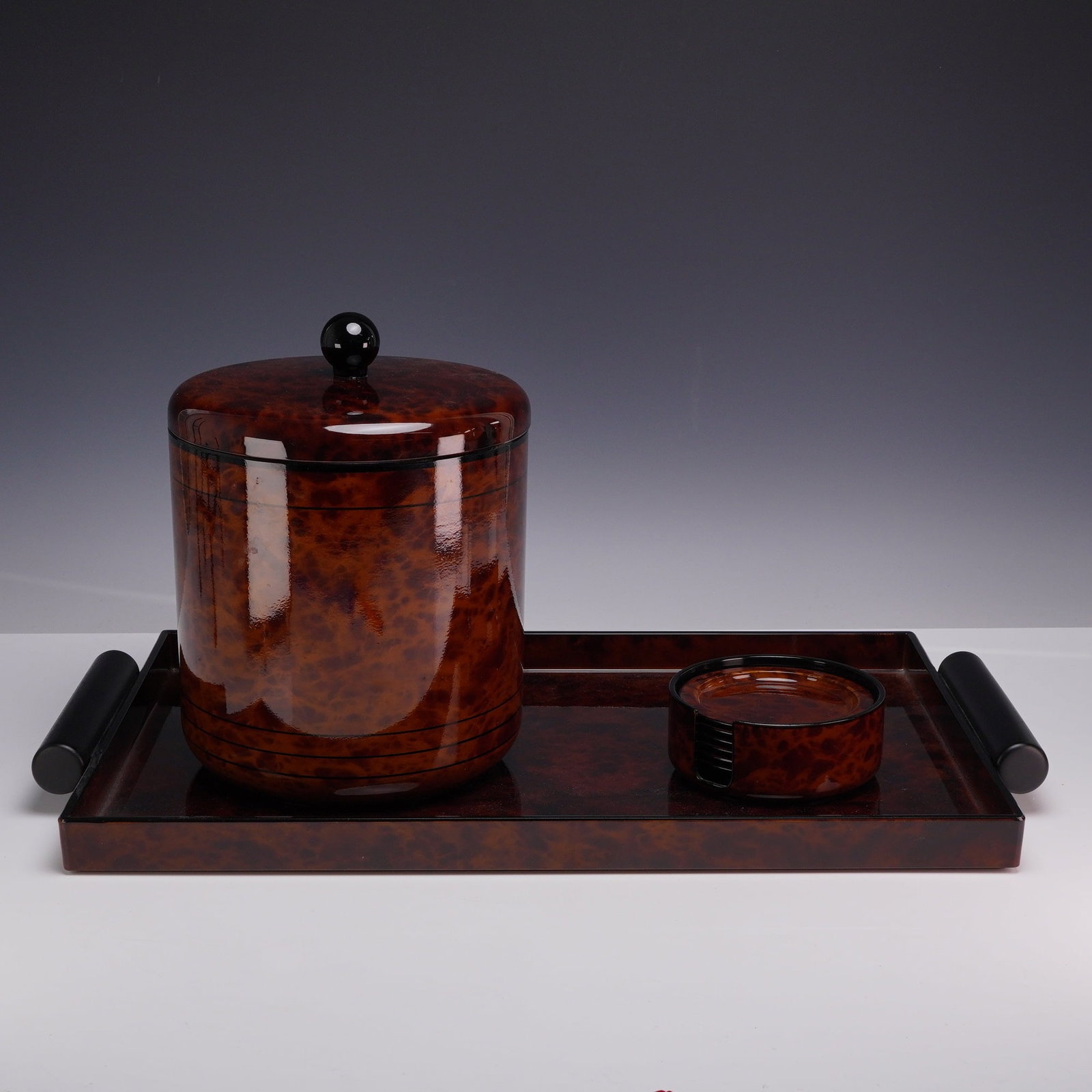 9pc Nancy Calhoun Lacquerware Ice Bucket, Coasters and Tray: A 9-piece barware collection by Nancy Calhoun Designs featuring a high-gloss lacquerware finish with a dark brown faux-tortoiseshell or burl pattern. The set comprises a cylindrical ice bucket with a 