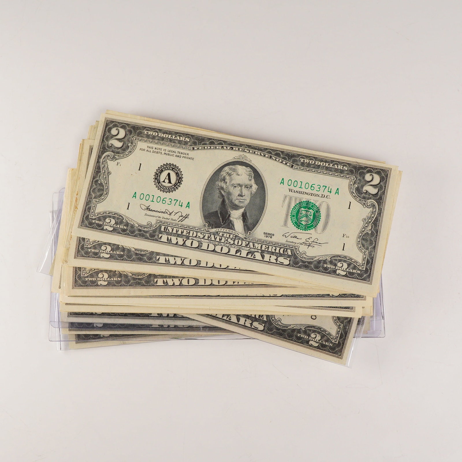 37pc 1976 and 1995 United States $2 Federal Reserve Notes: A 37-piece assortment from the 1976 and 1995 series. Each note features the familiar portrait of Thomas Jefferson at center with the green Treasury seal and serial numbers, marking these as modern leg