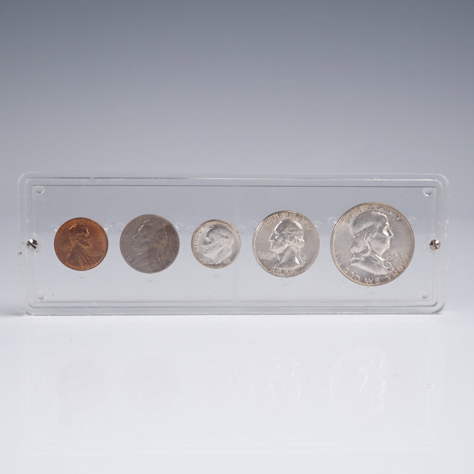 1958 United States 5 Coin Set: A vintage 1958 United States 5-coin set housed in a clear acrylic display holder. The set includes one each of the Franklin Half Dollar, Washington Quarter, Roosevelt Dime, Jefferson Nickel, and Linco