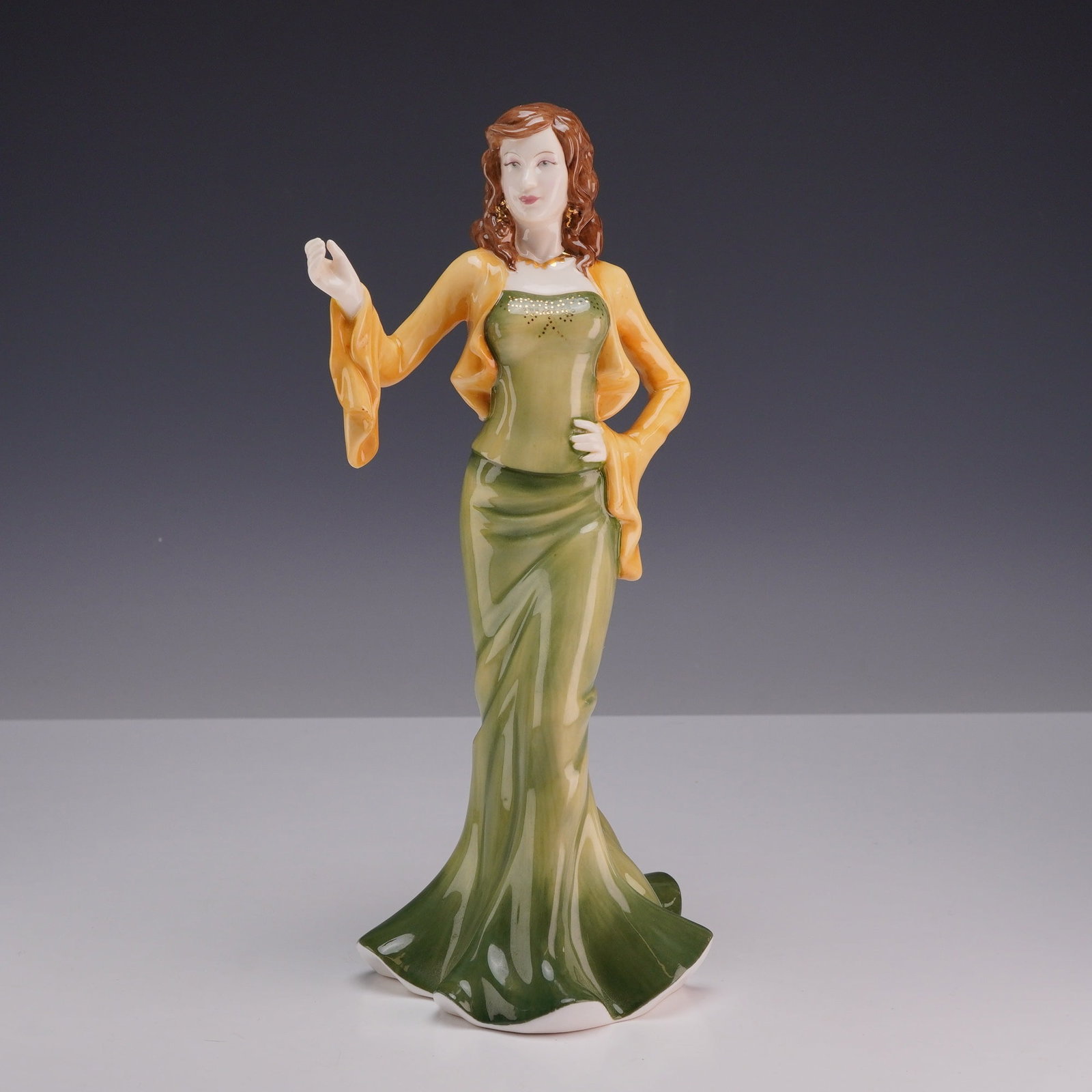 Royal Doulton Pretty Ladies Bone China Figurine Abigail HN 4858: A Royal Doulton glazed bone china figurine titled Abigail, model number HN 4858, from the Pretty Ladies collection. The figure is hand-made and hand-decorated, depicting a woman in a floor-length flar