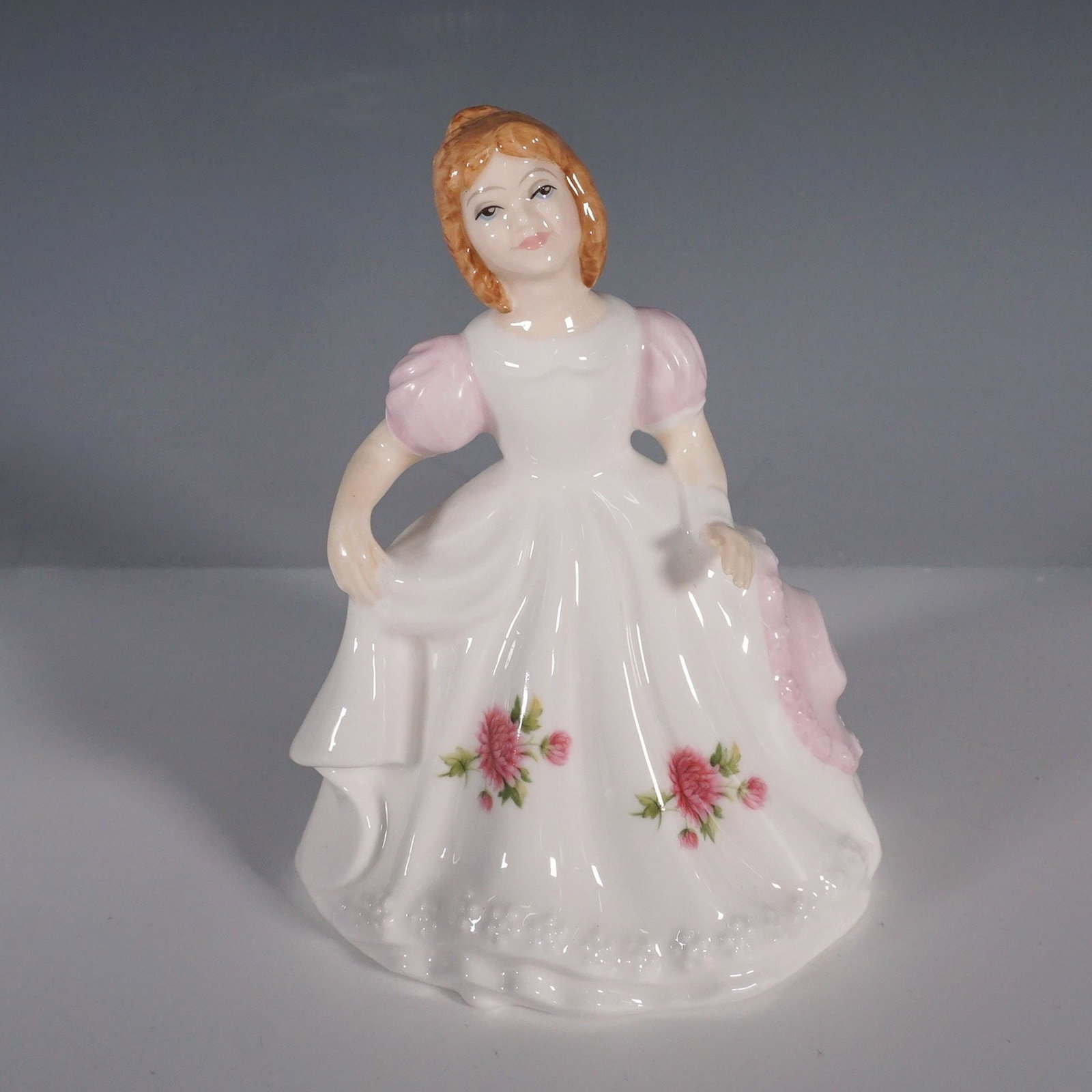 Royal Doulton, Figure of the Month, November, HN3328: This exquisite Royal Doulton figurine, Figure of the Month, November (HN 3328), was introduced in 1990 as part of the collectible Figure of the Month series. Designed by Robert Tabbenor, the figurine 