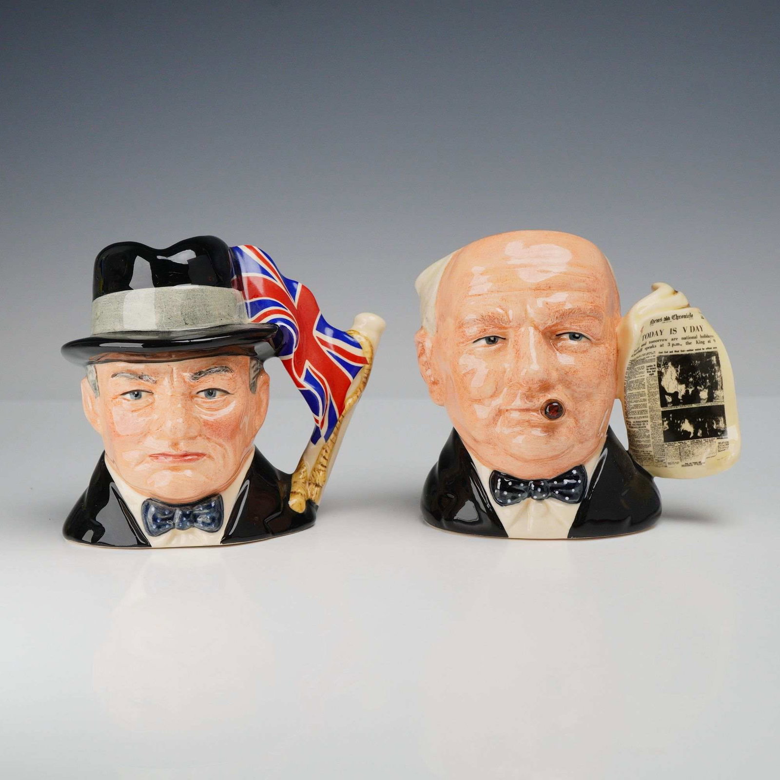 2pc Royal Doulton Small Character Jugs, D6849 and D6934: A pair of Royal Doulton hand-painted earthenware character jugs depicting the British Prime Minister Sir Winston Churchill. Both pieces were modeled by Stanley James Taylor and feature distinctive fig