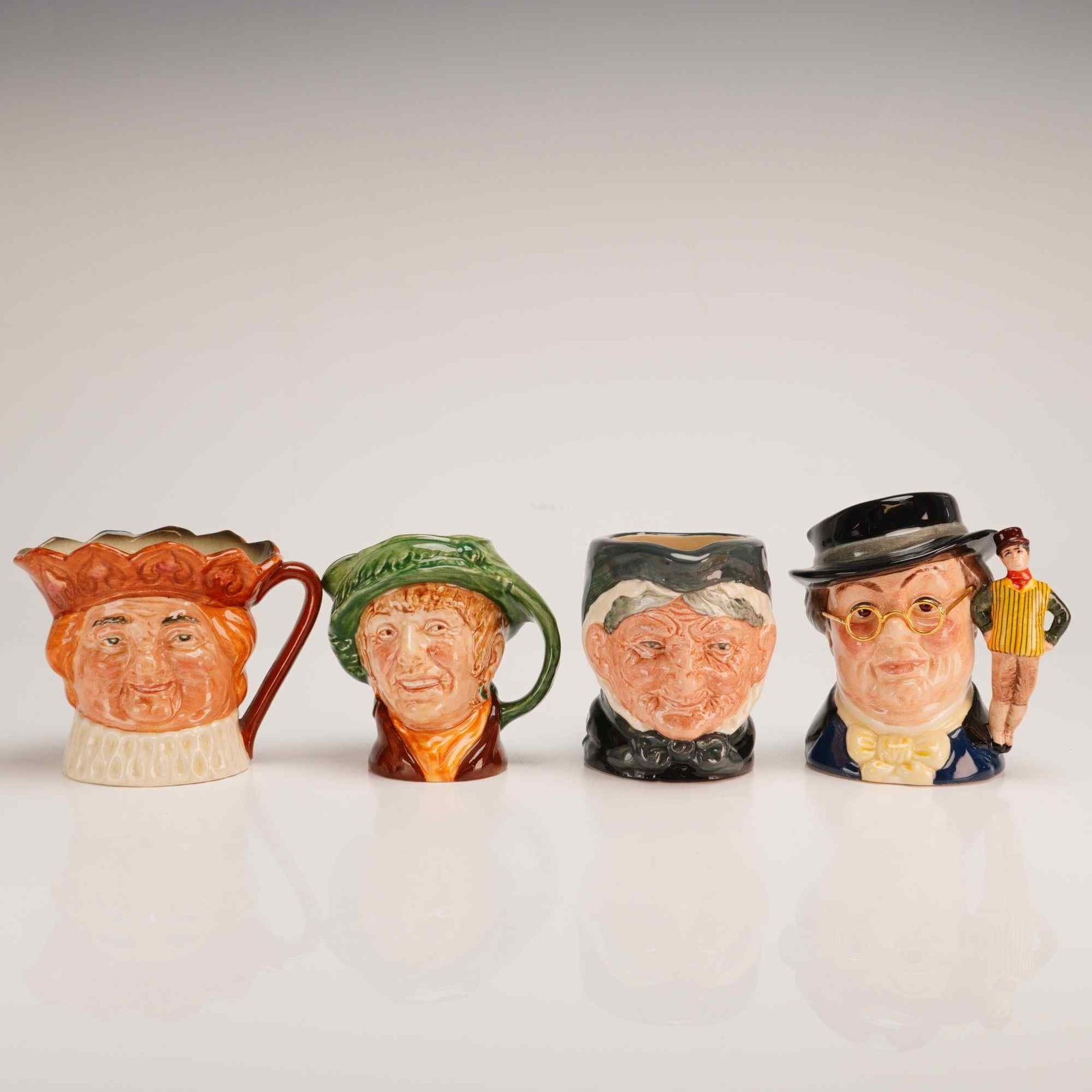 Lot of 4 Royal Doulton Character Jugs Including Mr. Pickwick and Granny: A collection of four Royal Doulton glazed earthenware character jugs of various sizes and series. This lot includes an International Royal Doulton Collectors Club exclusive Mr. Pickwick (D 7025) desig
