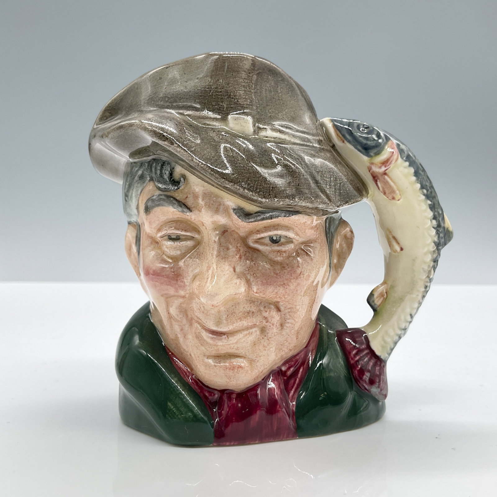 Poacher D6464 - Small - Royal Doulton Character Jug: Variation One. Green coat; red scarf; light brown hat. Royal Doulton backstamp. Artist: Max Henk Dimensions: 4"H Date or Era: 1957 - 1995 Manufacturer or Brand: Royal Doulton Country of Origin: <