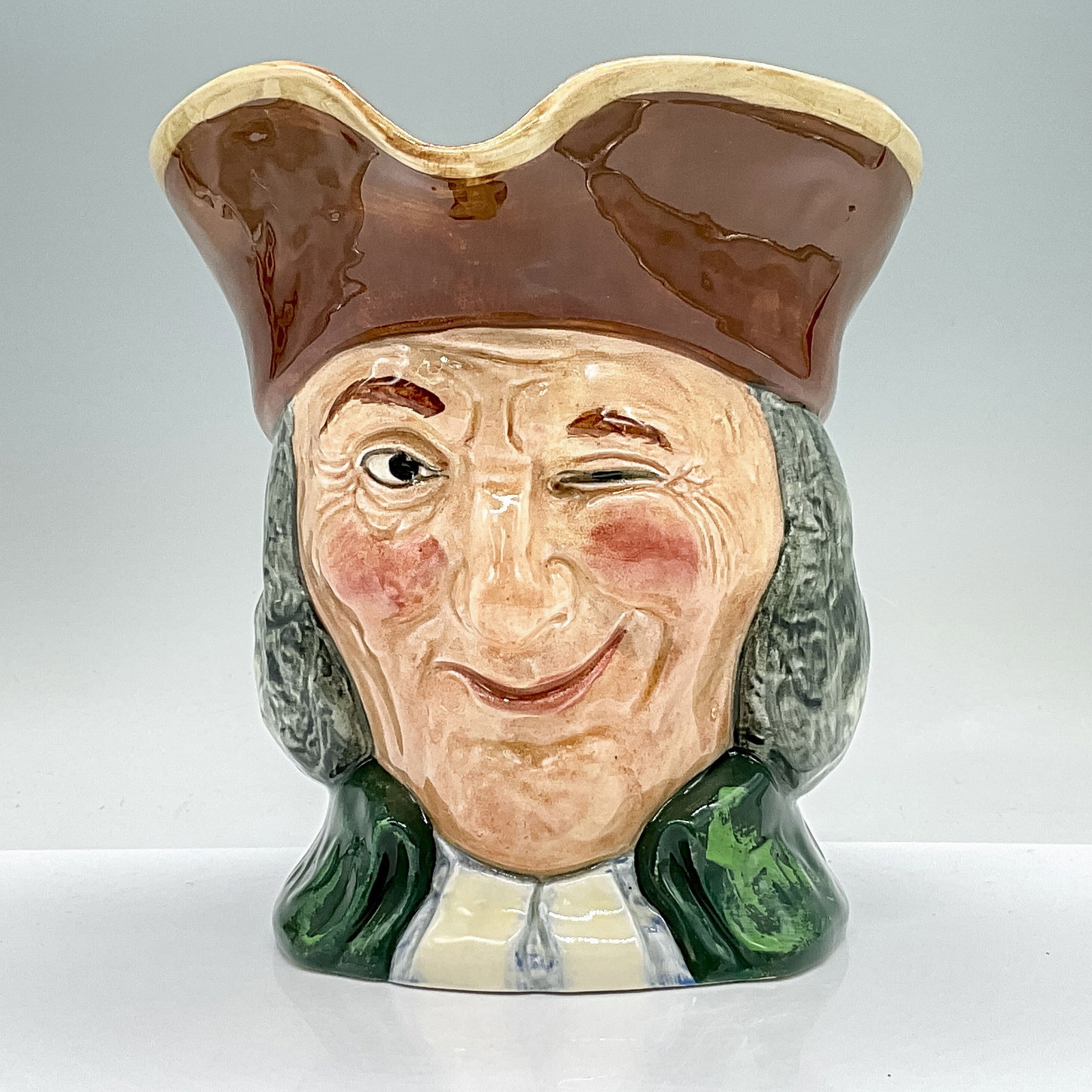Vicar of Bray D5615 - Large - Royal Doulton Character Jug: Brown hair, green coat. Royal Doulton backstamp. Artist: Charles J. Noke and Henry Fenton Dimensions: 6.75"H Date or Era: 1936 - 1960 Manufacturer or Brand: Royal Doulton Country of Origin: E