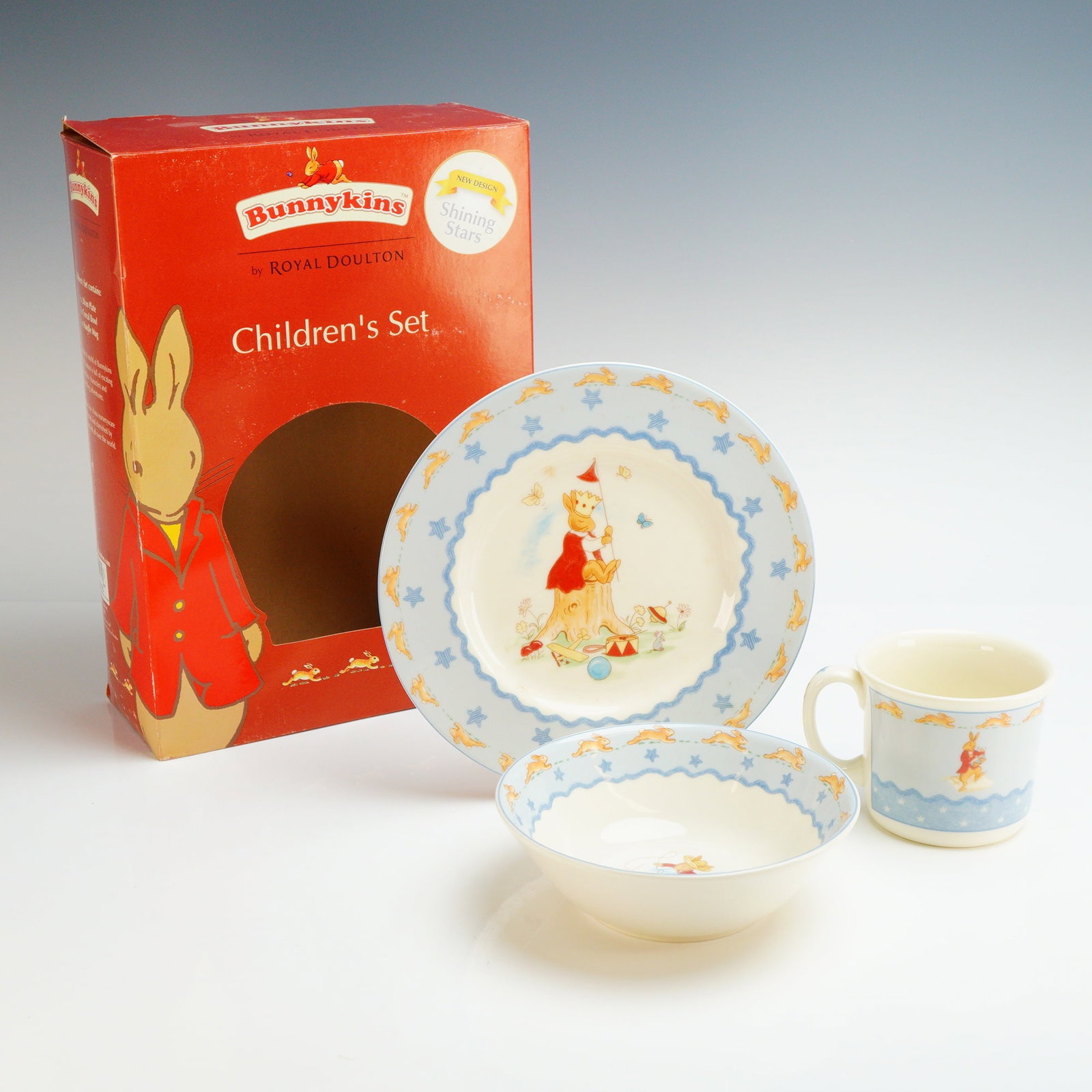 Royal Doulton Bunnykins Children's 3-Piece Nurseryware Set: The set is designed with the Bunnykins Shining Stars pattern. The set is constructed of bone china and includes a plate, a bowl, and a single-handle mug. Each piece features central vignettes of anthr
