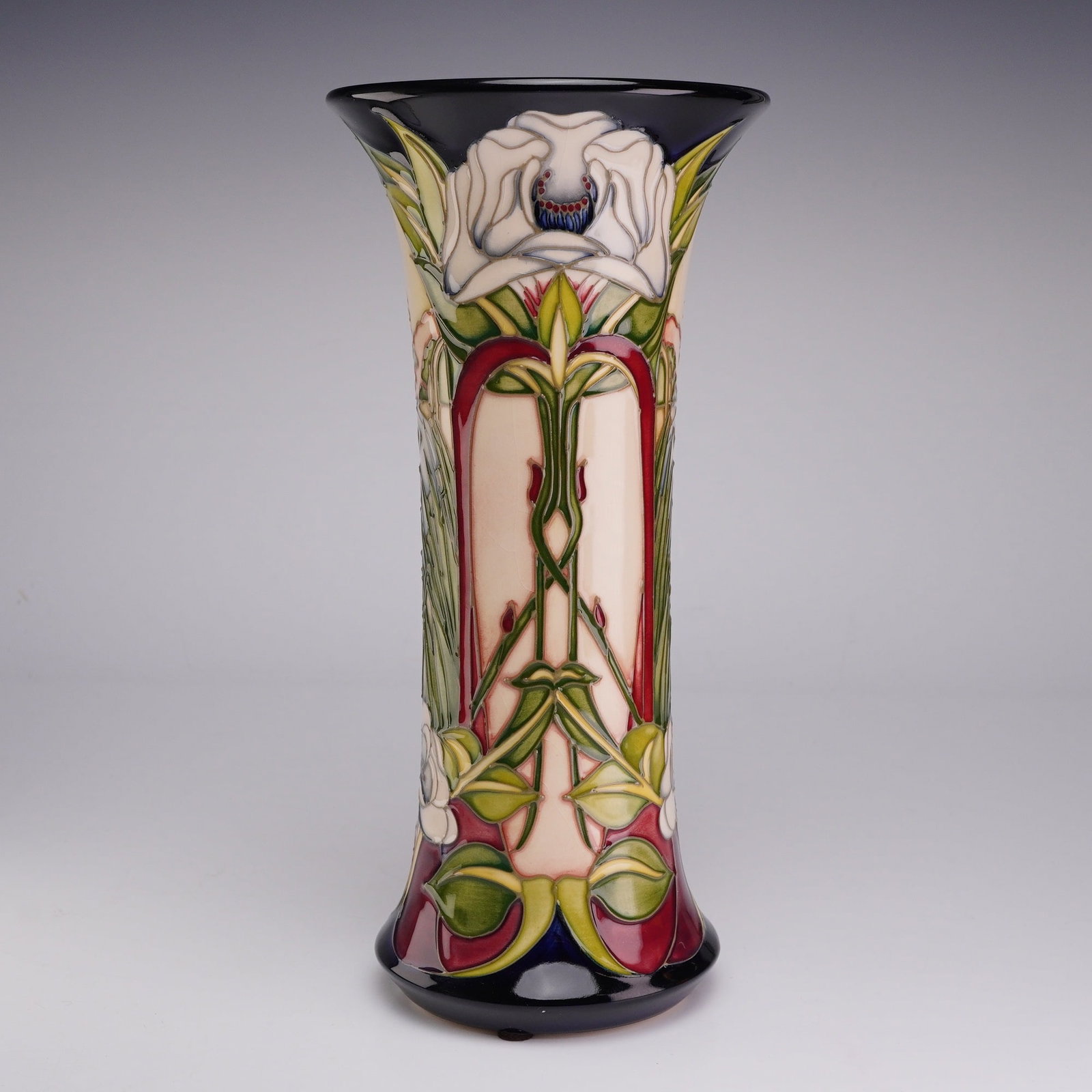 Moorcroft Pottery by Philip Gibson Limited Edition Vase Made for MacIntyre, Fountains Abbey: This glazed earthenware vase features a tall, waisted cylindrical body with a flared rim and a slightly flared foot. The exterior is decorated in the Art Nouveau style using the tube-lining technique 