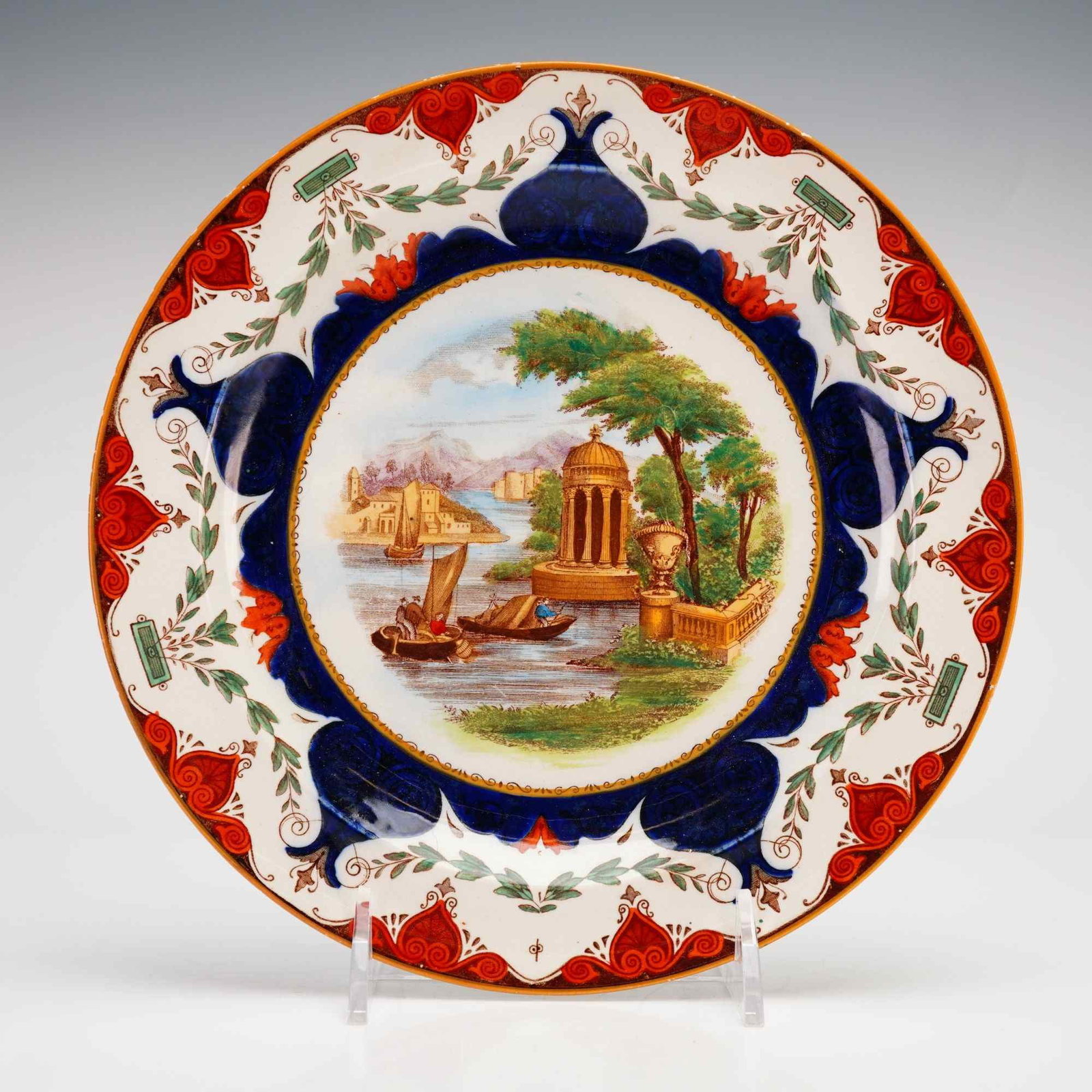 Wedgwood Porcelain Plate with Capriccio Landscape: This Wedgwood porcelain plate, dating to circa 1825, features a polychrome transfer-printed and hand-colored central medallion depicting a classical capriccio landscape. The scene includes a rotunda,