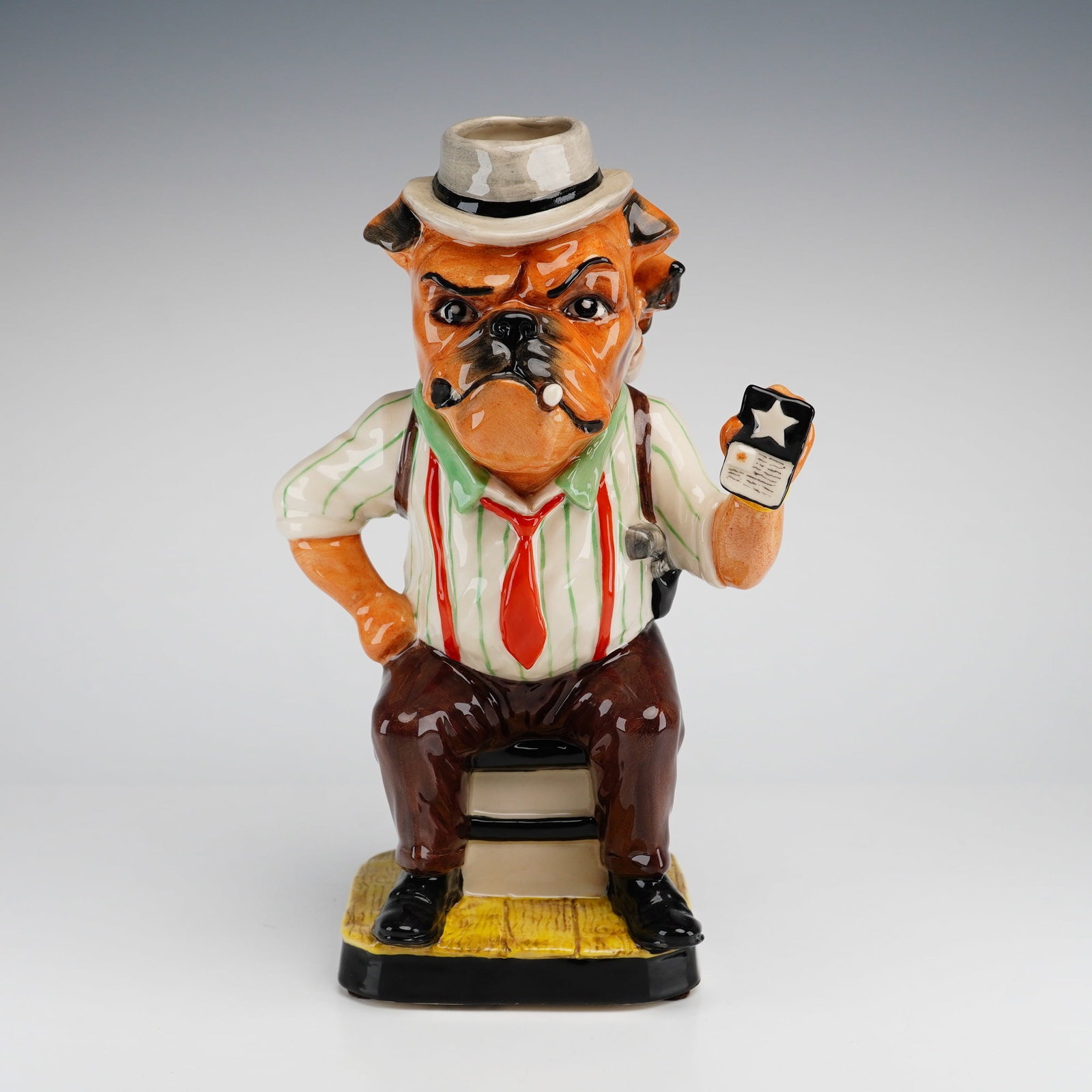 Kevin Francis Peggy Davies Ceramics Limited Edition Figurine, Bulldogedness: The hand painted piece features an anthropomorphic bulldog character portrayed as a classic film noir detective. The bulldog is depicted with a stern expression, clenching a cigar in his mouth and hol