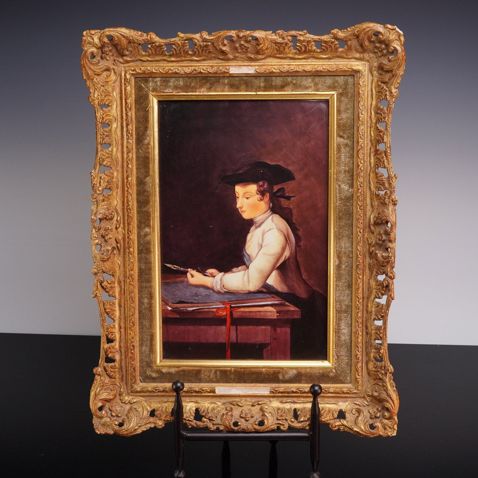 After Jean-Simeon Chardin (France 1699-1779) Hand-Painted Porcelain Plaque, The Young Draughtsman: This hand-painted porcelain plaque is a high-quality rendering of the 1737 original painting Le Jeune Dessinateur (The Young Draughtsman) by French artist Jean-Simeon Chardin. The scene portrays a you