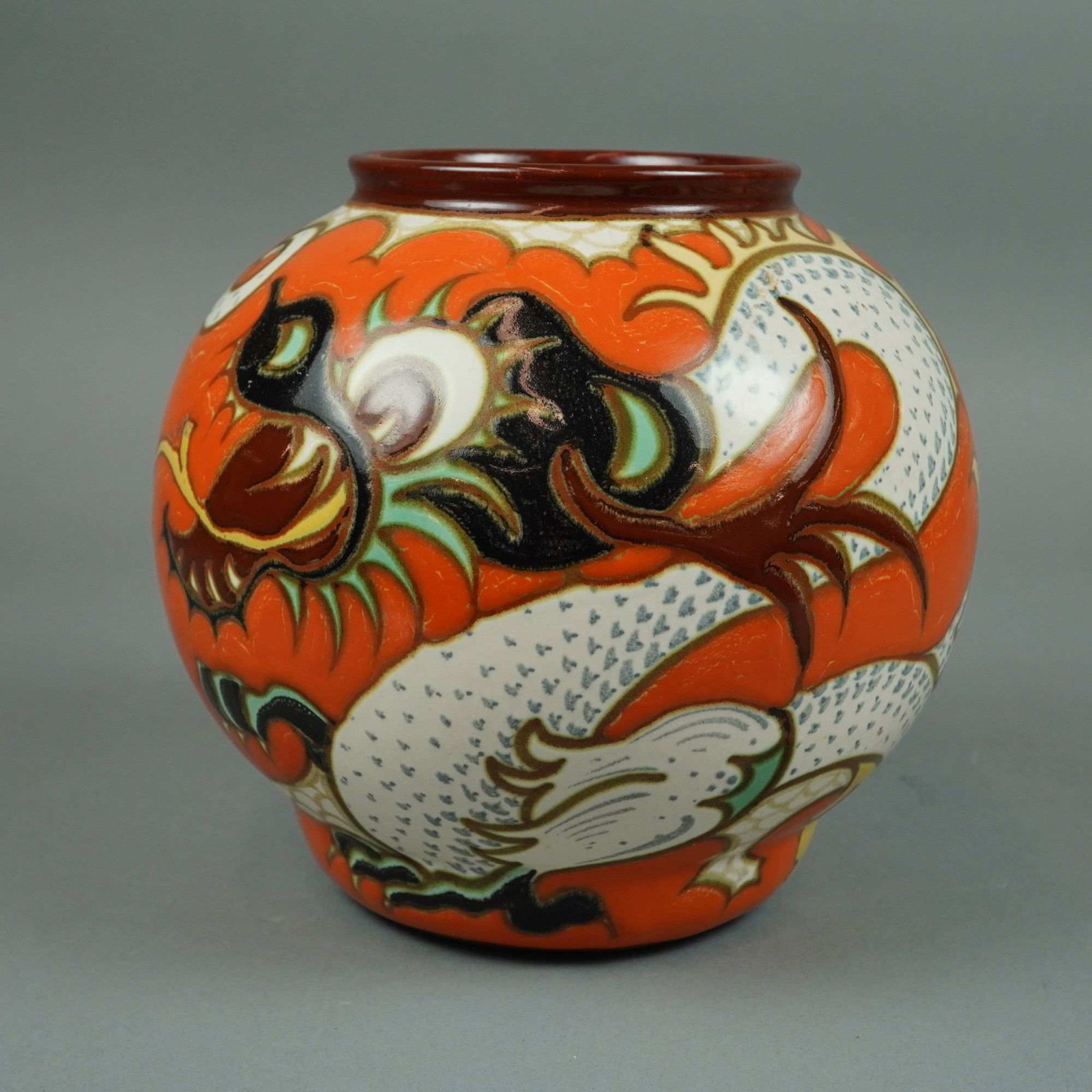 Art Deco Pudora Pattern Dragon Vase, Gouda, Holland: An Art Deco period earthenware bulbous jar manufactured by Plateelbakkerij Zuid-Holland (P.Z.H.) in Gouda, Holland. This vase features the hand-painted Pudora pattern, which depicts a large, dragon mo
