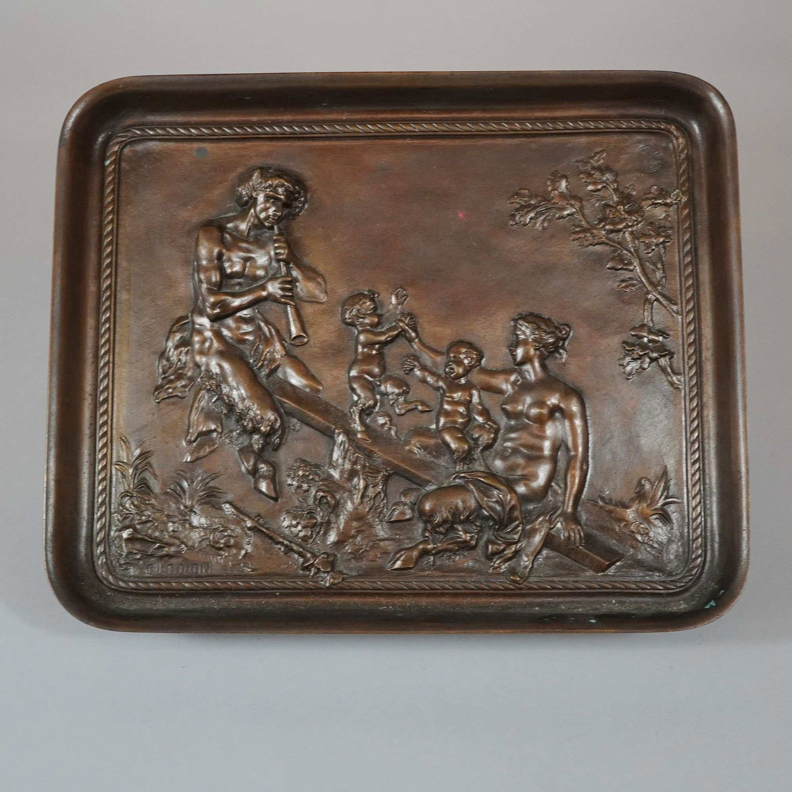 After Clodion French Neoclassical Bronze Footed Tray with Mythological Scene: This bronze footed tray features a high-relief rectangular plaque depicting a mythological sylvan scene after the French sculptor Claude Michel, known as Clodion. The central composition depicts a sea