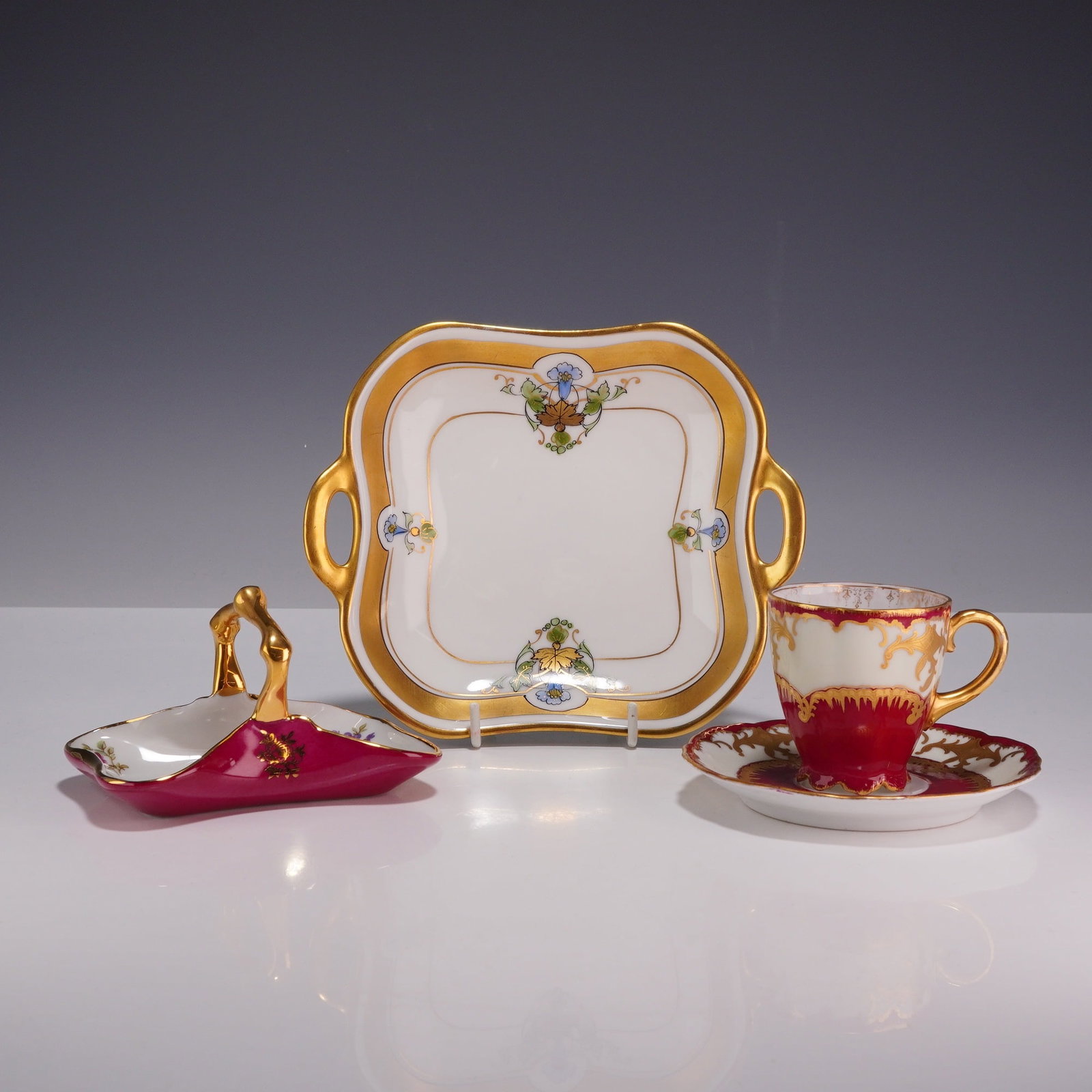 4pc Rosenthal, Limoges, and Pickard Teacup, Saucer, and Trays: This grouping consists of four decorative porcelain items originating from prominent European and American makers. The group includes a demitasse cup and matching saucer in the Malmaison pattern by