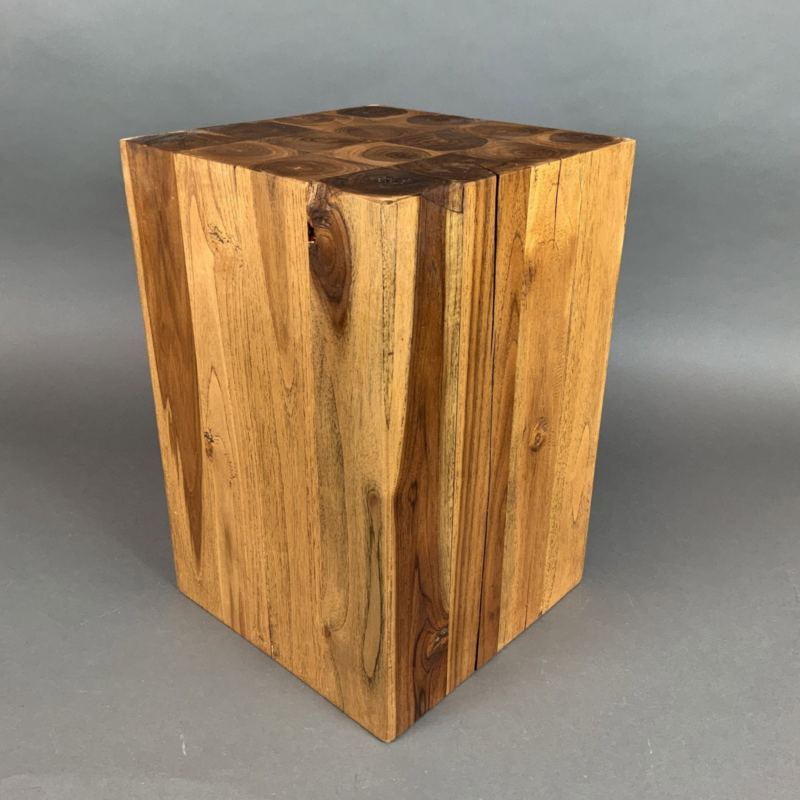 Natural Solid Wood Cube Pedestal or Side Table: A natural solid wood side table or pedestal in a minimalist, sculptural form. The piece is constructed from multiple laminated timbers of a warm, golden-brown hardwood, exhibiting characteristic