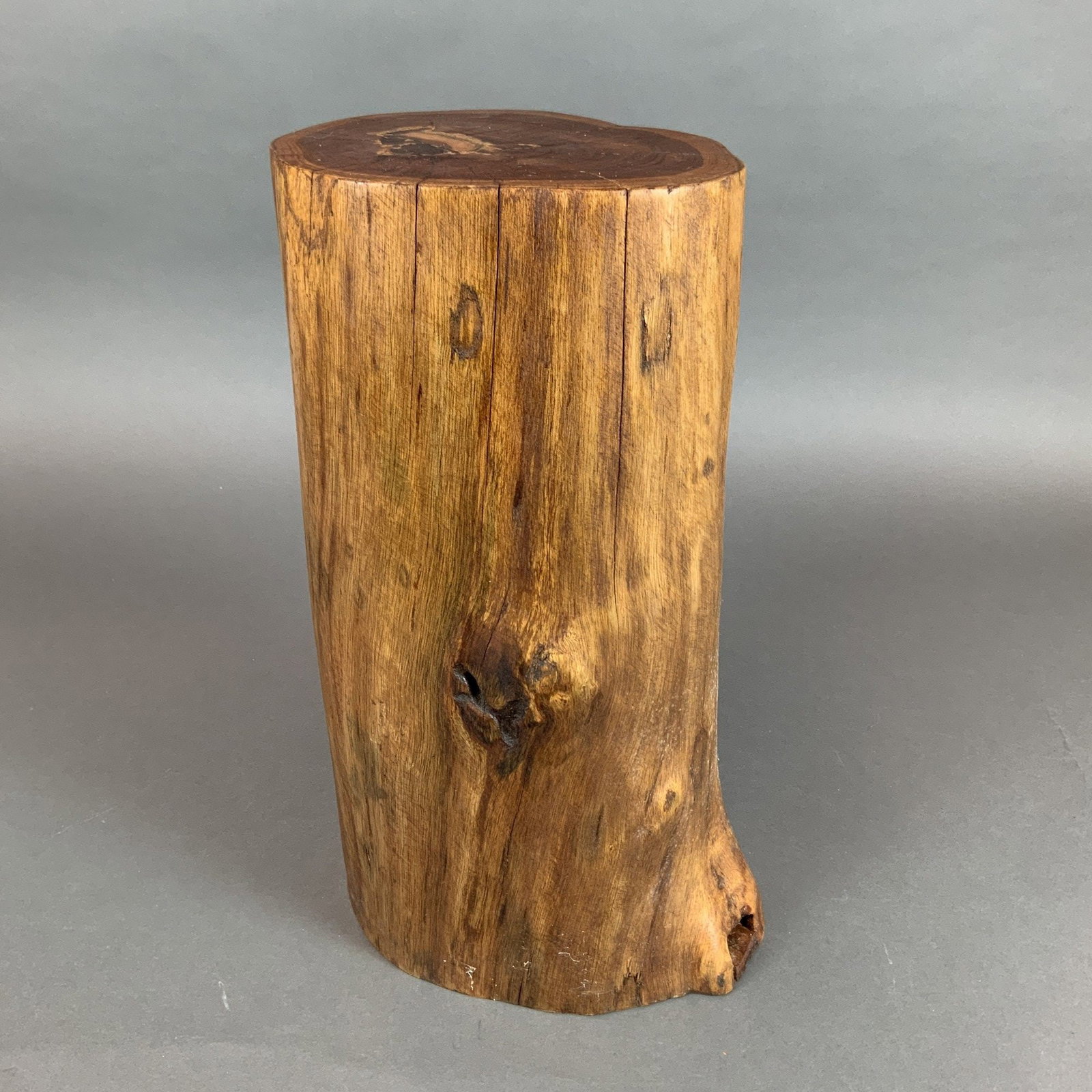 Natural Tree Trunk Polished Solid Wood Side Table or Stand: A decorative side table or stand fashioned from a single section of a polished tree trunk. The piece is constructed from solid hardwood, displaying a distinct visual contrast between the dark brown