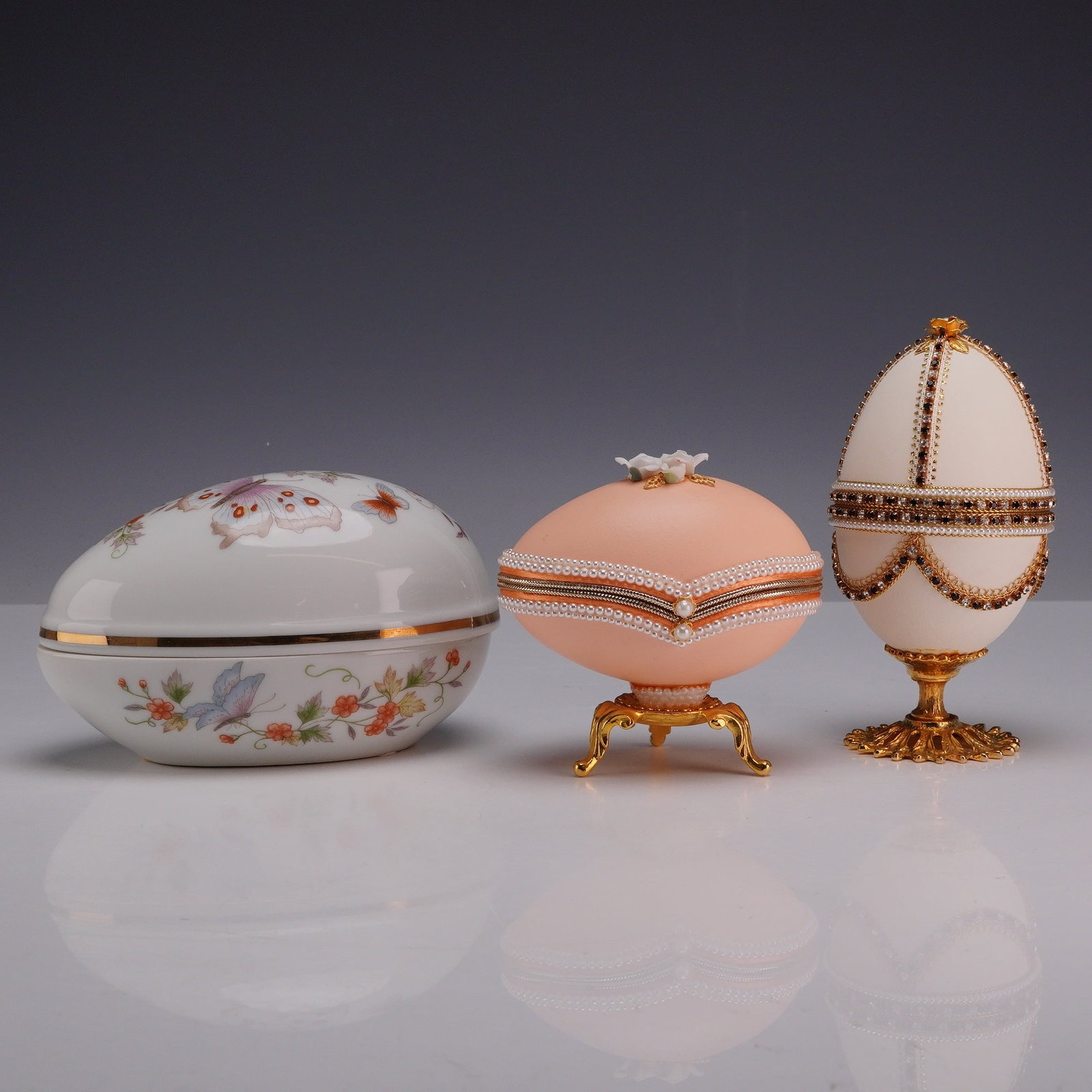 A Trio of Decorative Egg-Shaped Trinket Boxes Including Avon and Eggspressions (1 of 5)