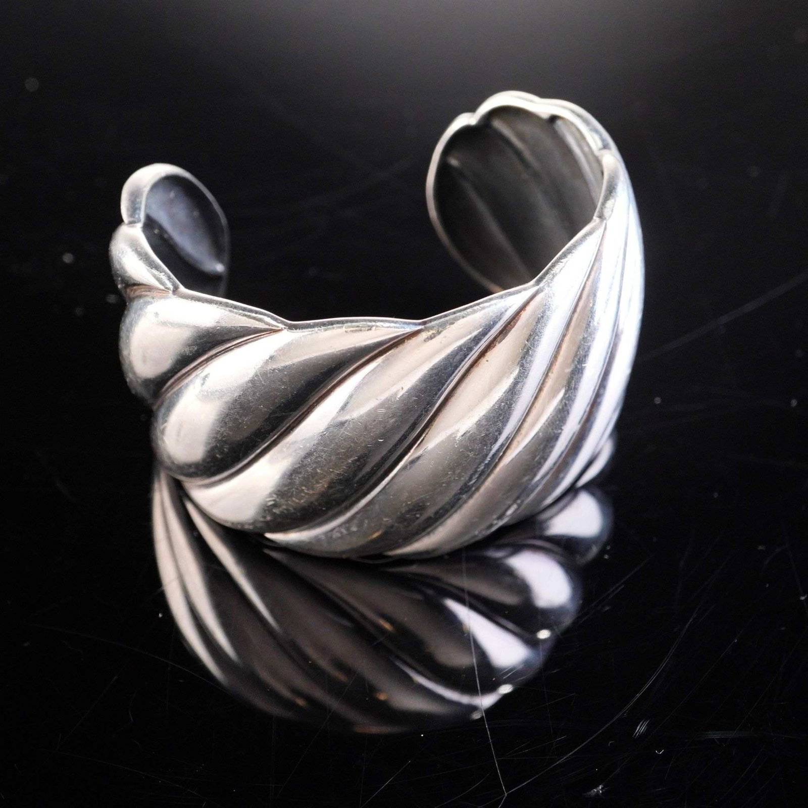 David Yurman Sterling Silver Sculpted Cable Wide Cuff Bracelet: This David Yurman wide cuff bracelet is designed in the signature Sculpted Cable pattern. The piece is constructed from sterling silver, which has been verified through testing with a Thermo Scientifi